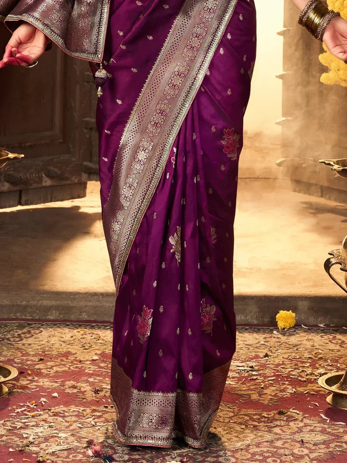 Purple designer saree with gold floral embroidery and intricate border, perfect for ethnic occasions
