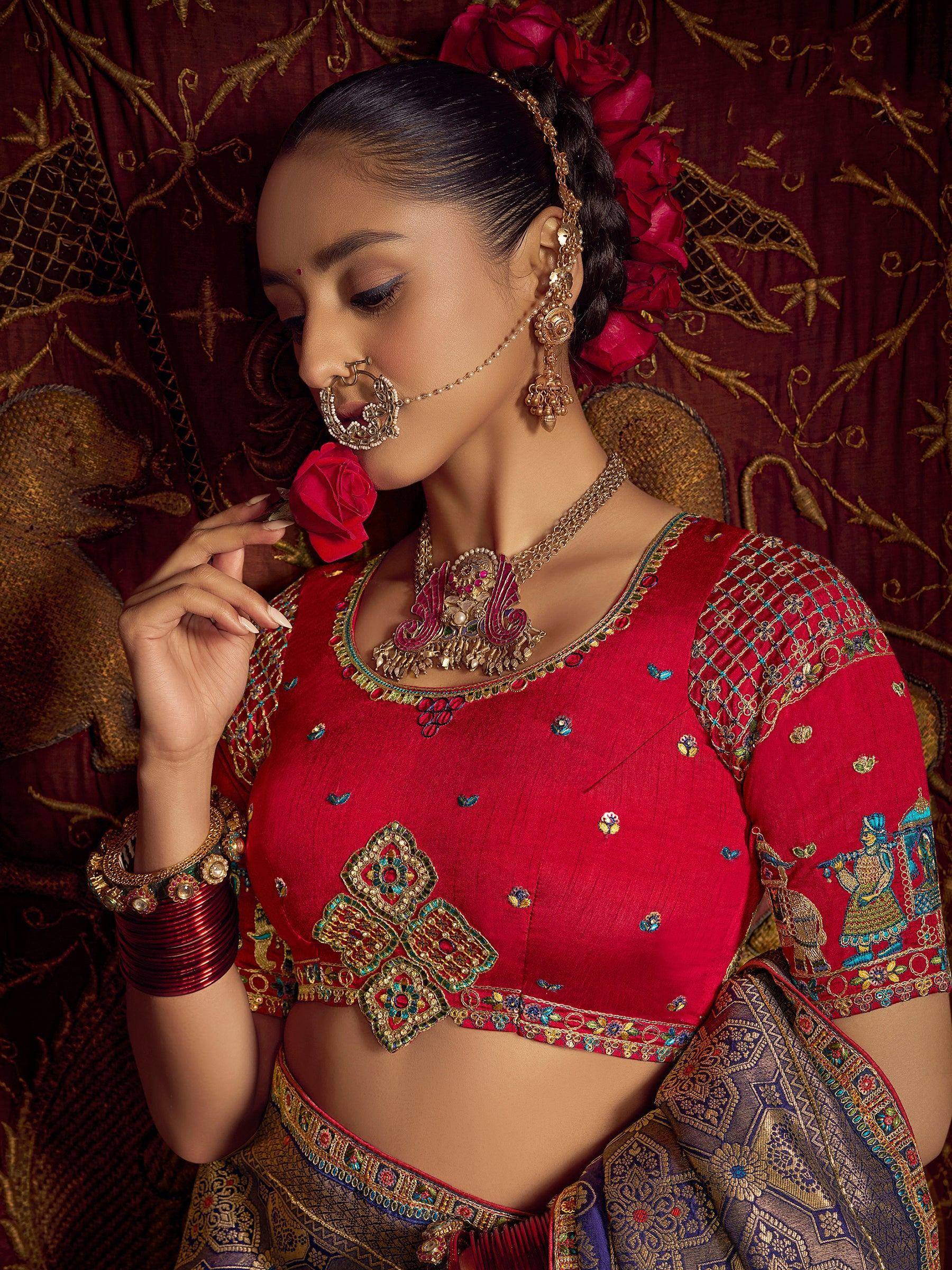 Red embroidered lehenga choli with gold jewelry, perfect for Indian weddings and festive occasions.