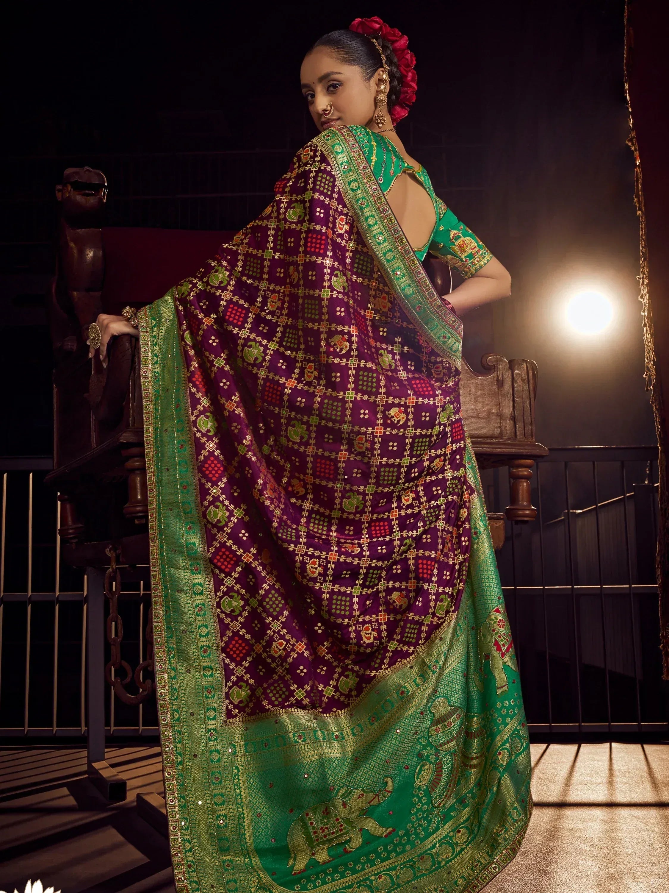 Woman in purple and green designer saree with elephant print, traditional Indian ethnic wear
