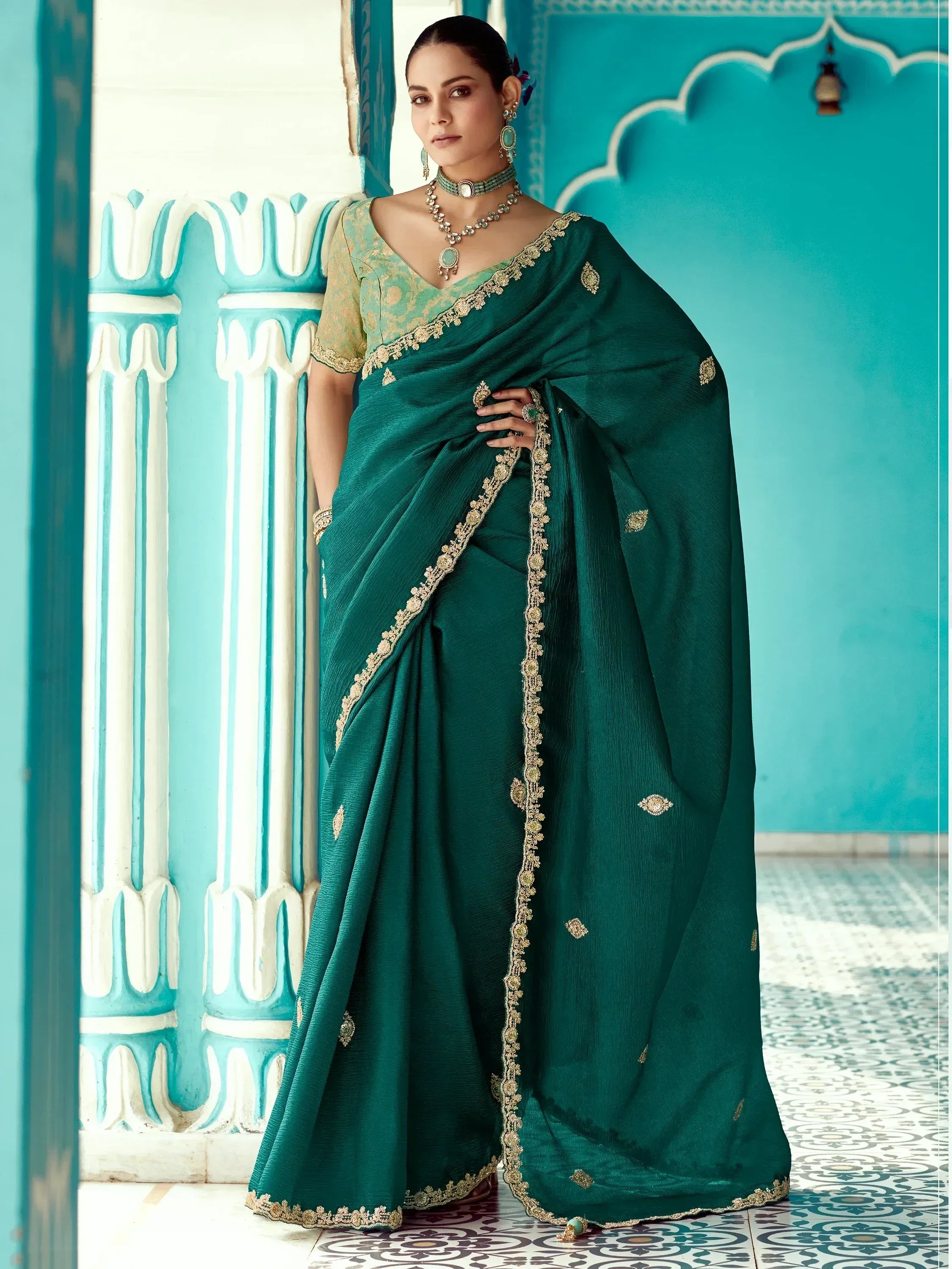 Emerald green designer saree with gold embroidery, perfect for Indian ethnic wear occasions.