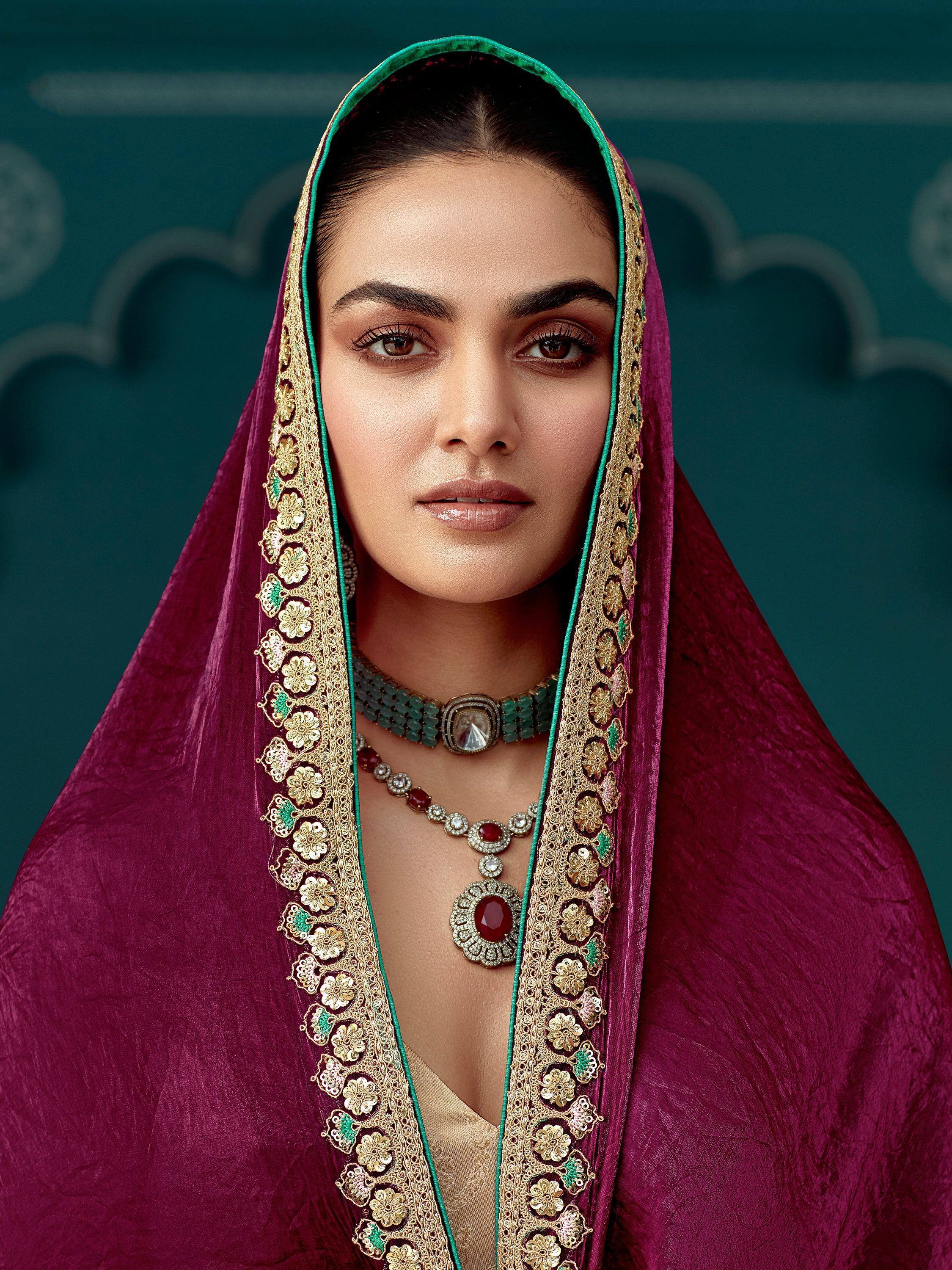 Elegant woman in maroon ethnic dupatta with gold embroidery and traditional Indian jewelry