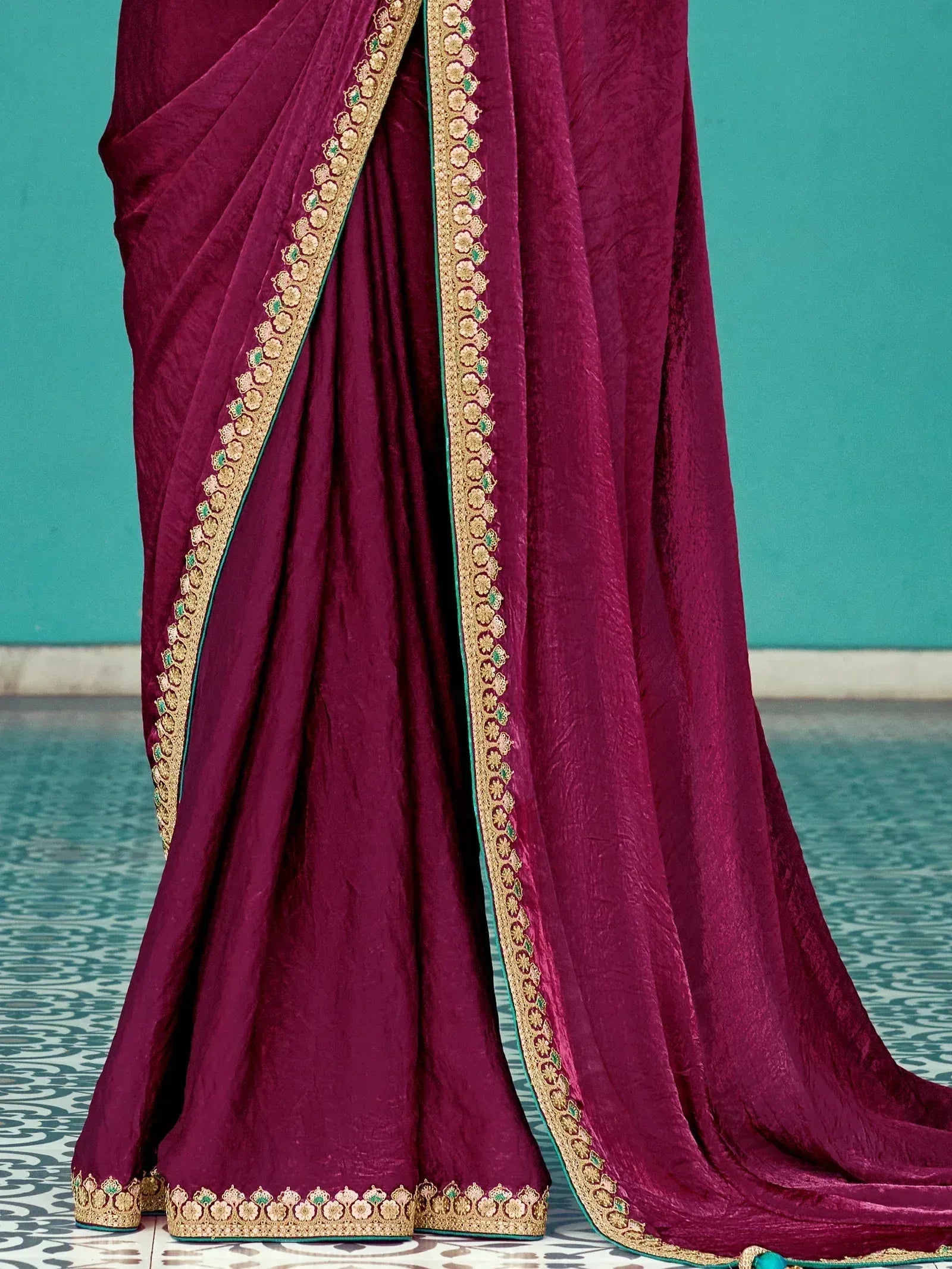 Rich maroon saree with gold and green floral embroidery, perfect for Indian ethnic wear occasions