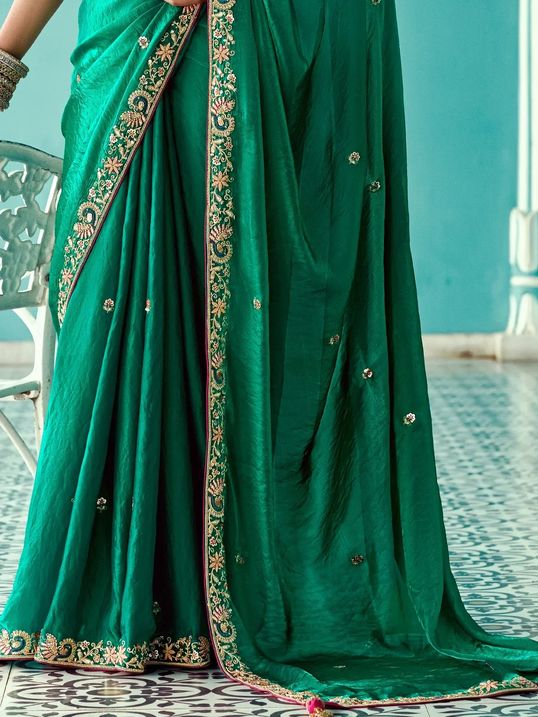 Emerald green saree with intricate gold floral embroidery and border, perfect for Indian ethnic occasions.
