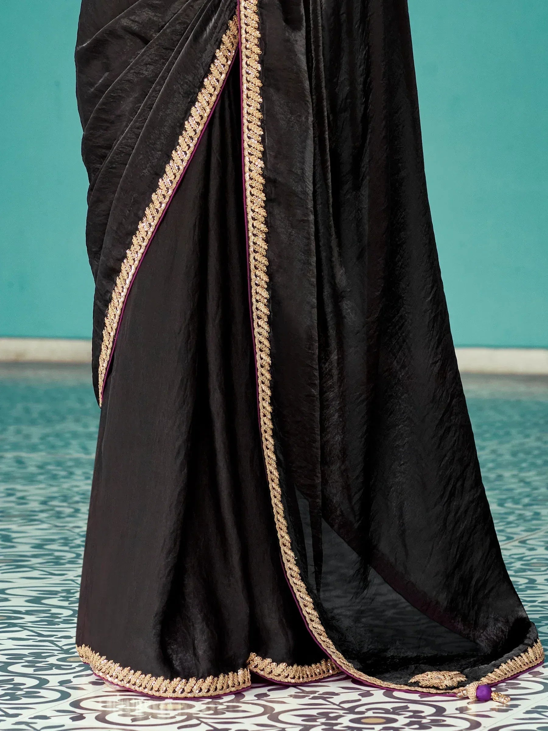 Black velvet saree with gold embroidery and purple trim, elegant Indian ethnic wear
