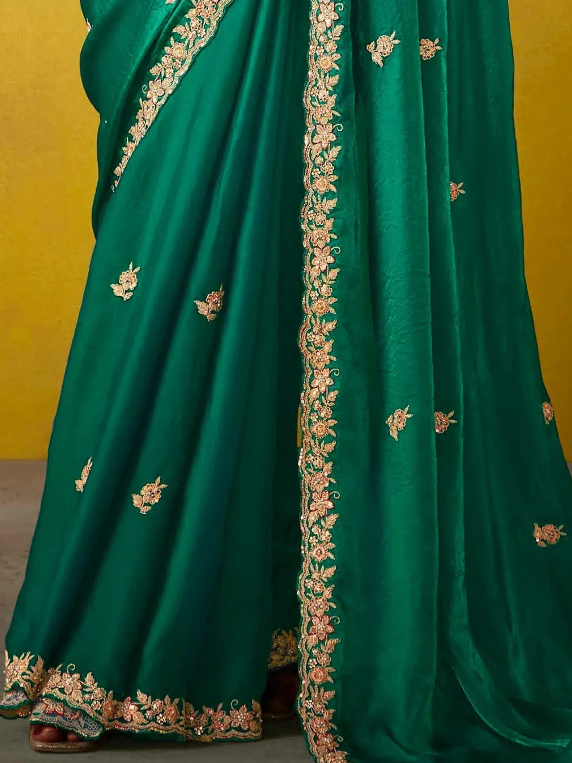 Emerald green designer saree with gold floral embroidery and border, ethnic Indian wear