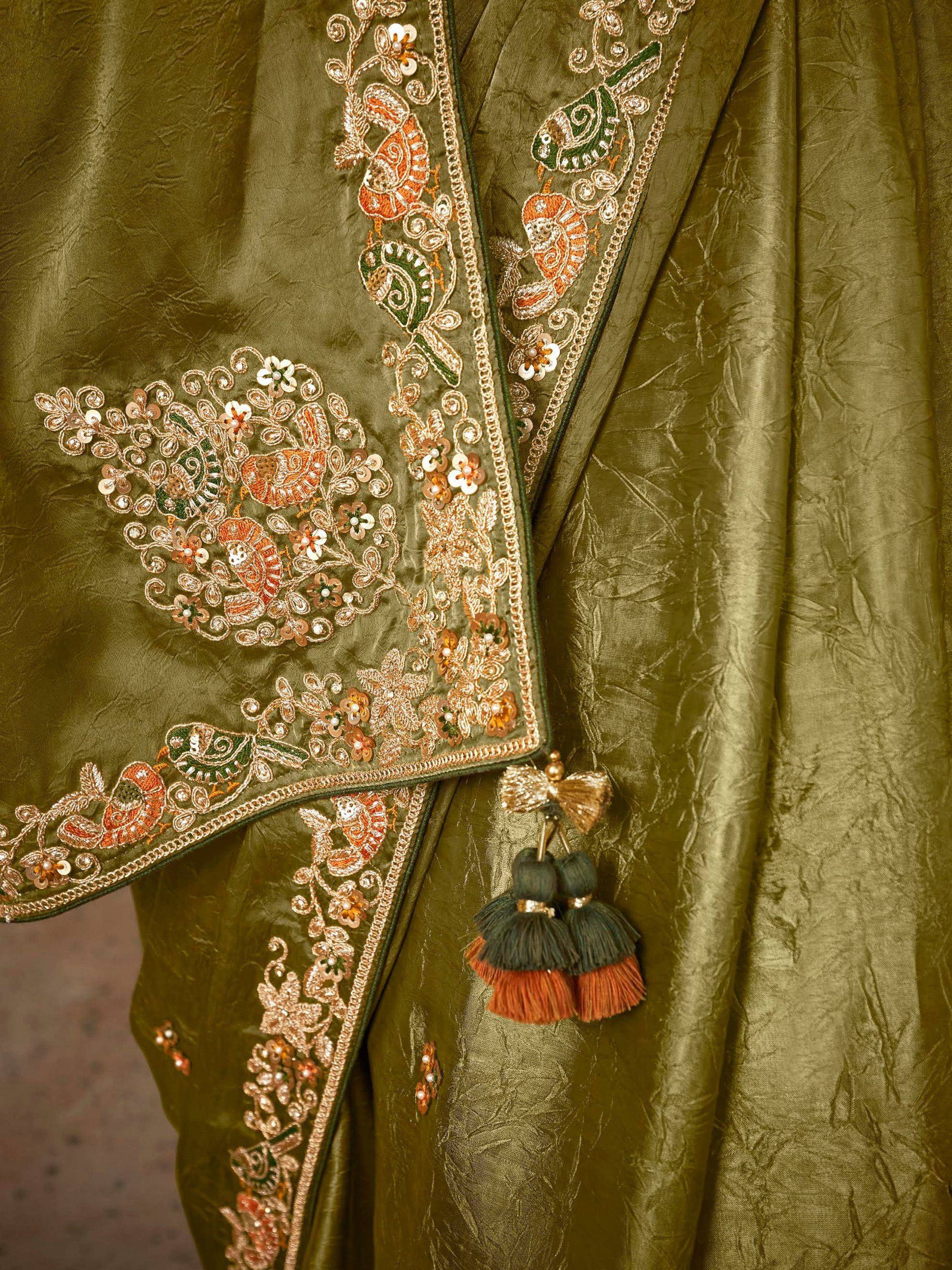 Olive green ethnic wear with intricate bird and floral embroidery, sequins, and tassels