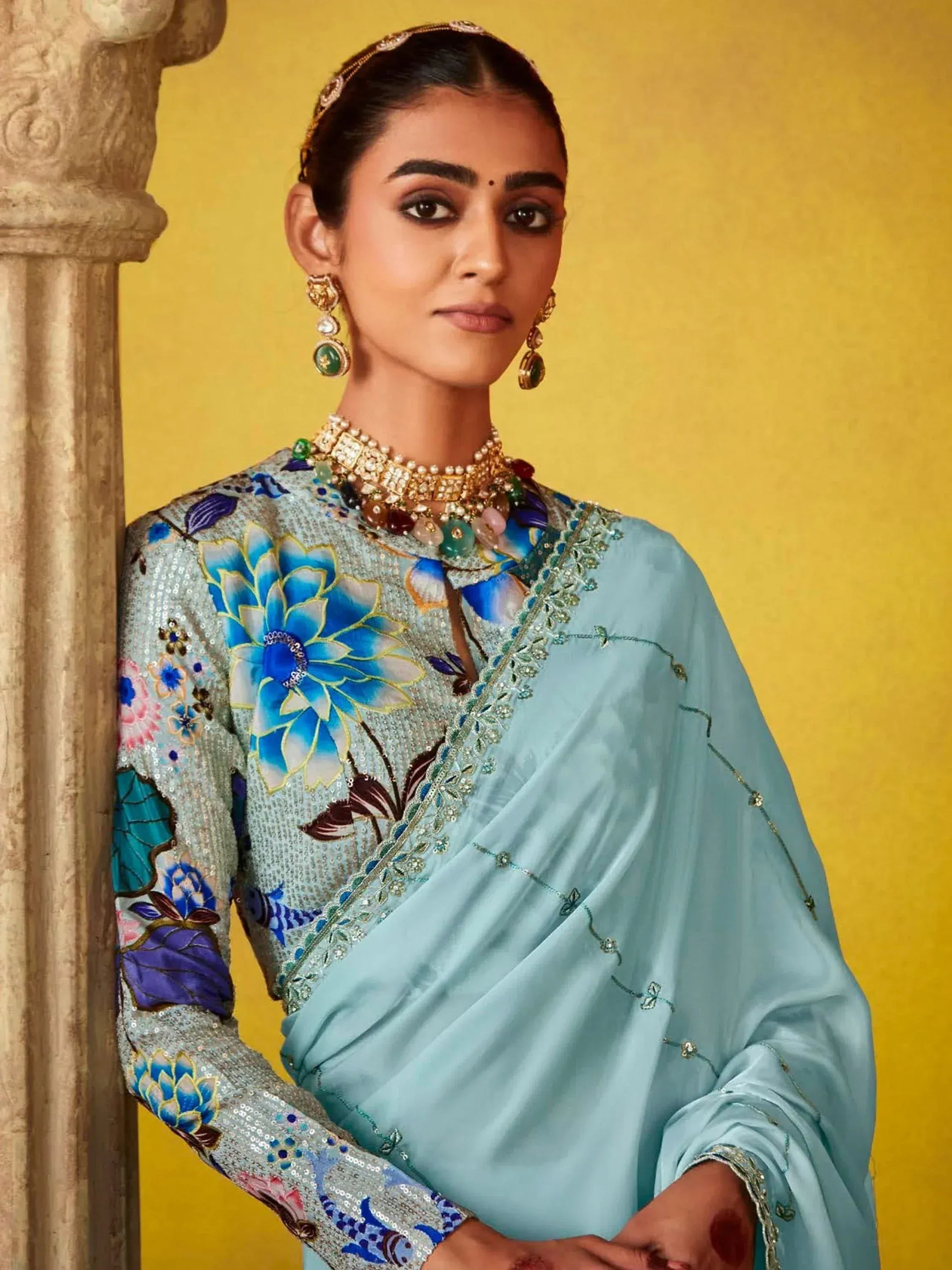 Woman in light blue floral embroidered saree with statement jewelry, Indian ethnic wear