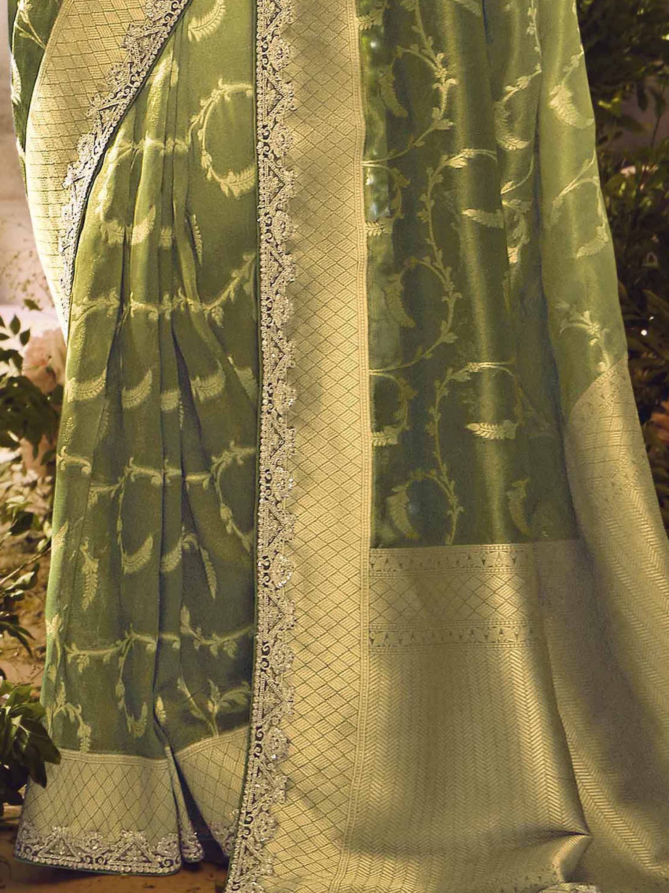 Olive green ethnic saree with gold floral embroidery and lace border, perfect for Indian weddings or festivals
