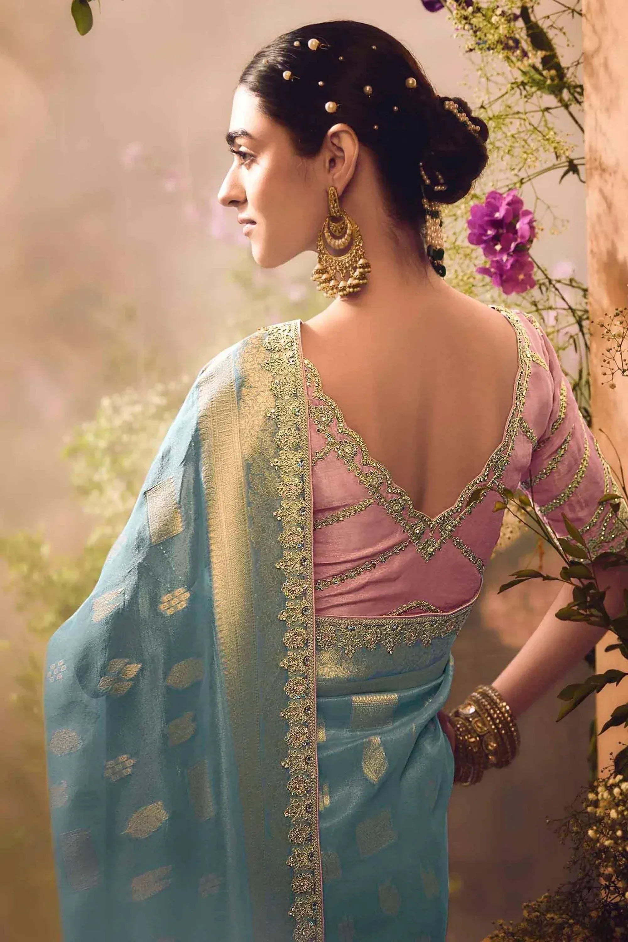 Elegant Indian saree with pink blouse, gold embroidery, and blue dupatta, styled with traditional jewelry for festive occasions.