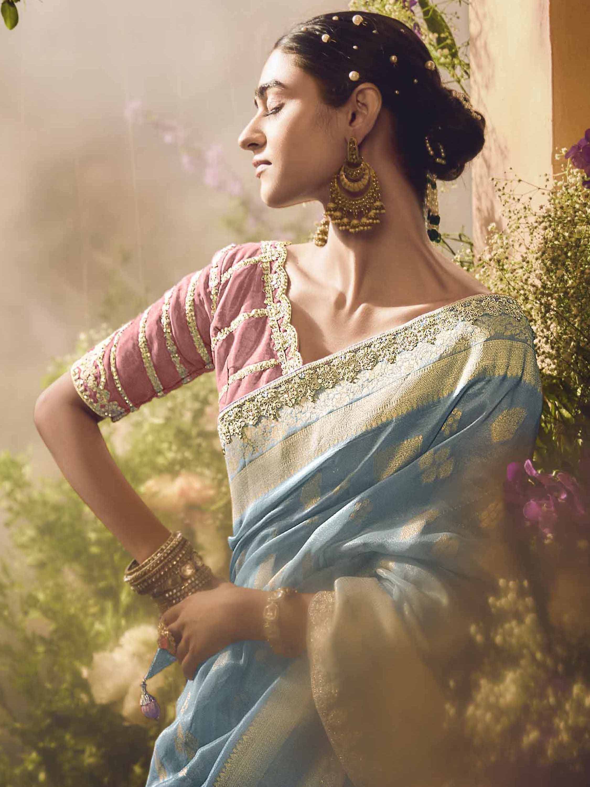 Elegant woman in blue and gold saree with pink embroidered blouse, traditional Indian ethnic wear