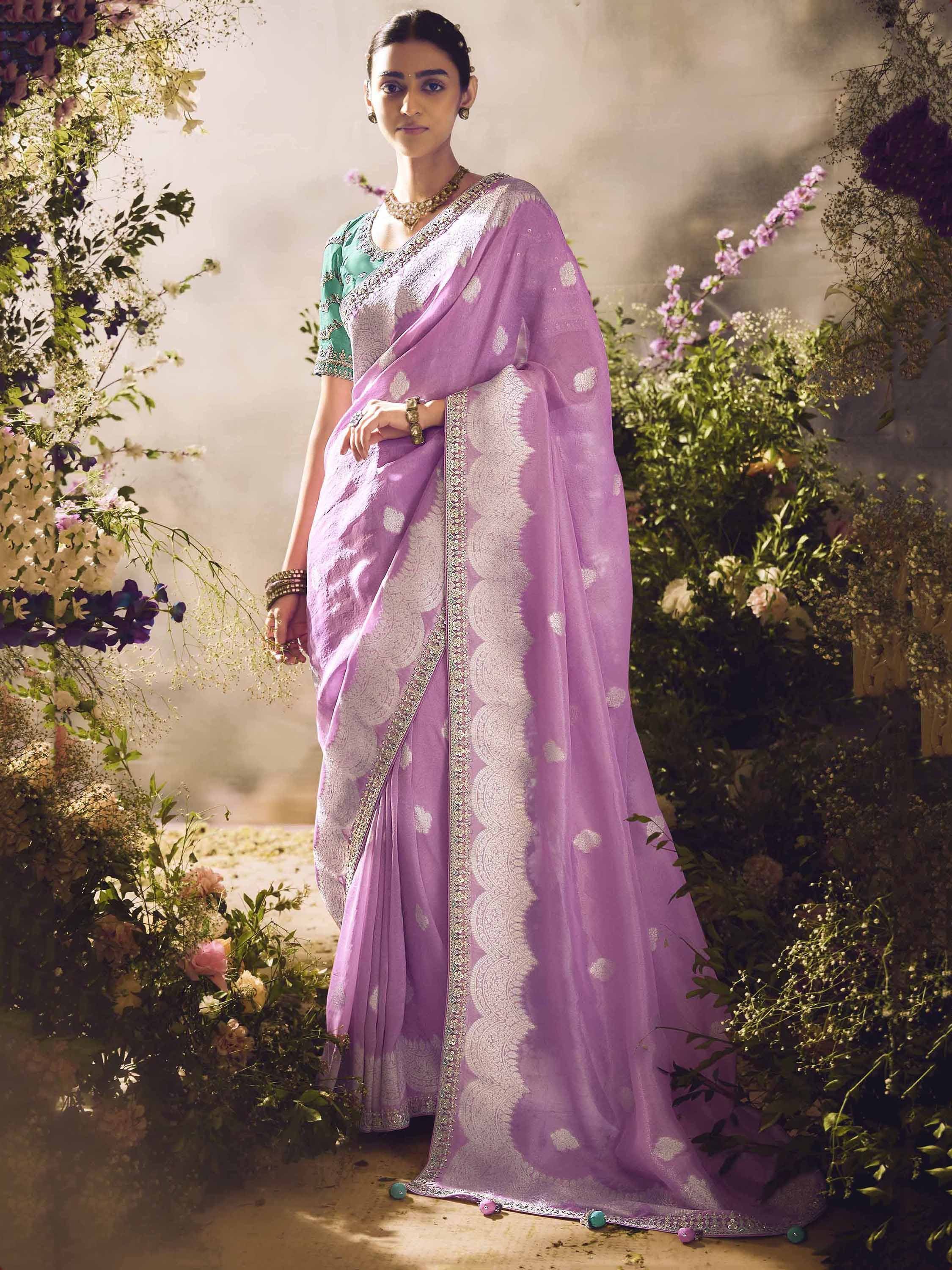 Lavender ethnic saree with silver embroidery and green blouse, styled for Indian occasions