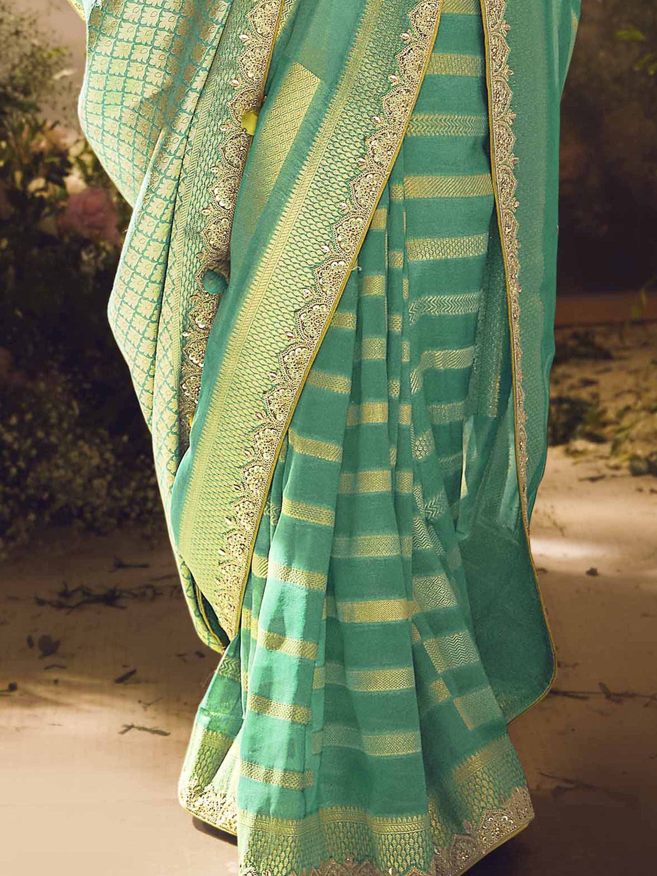 Emerald green saree with gold zari stripes and intricate embroidery, perfect for ethnic occasions.