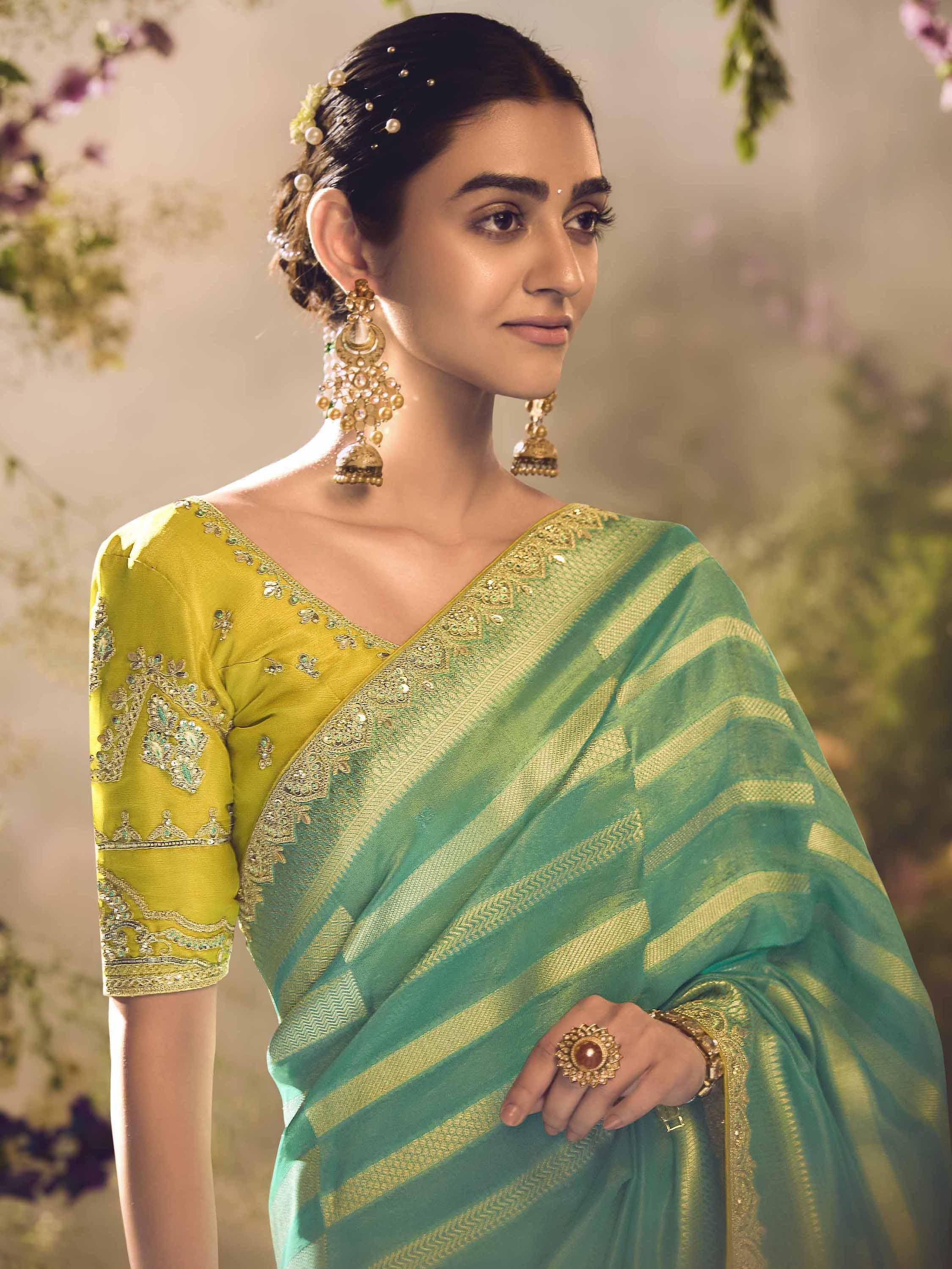 Elegant green and gold striped saree with embroidered blouse, perfect for Indian ethnic occasions