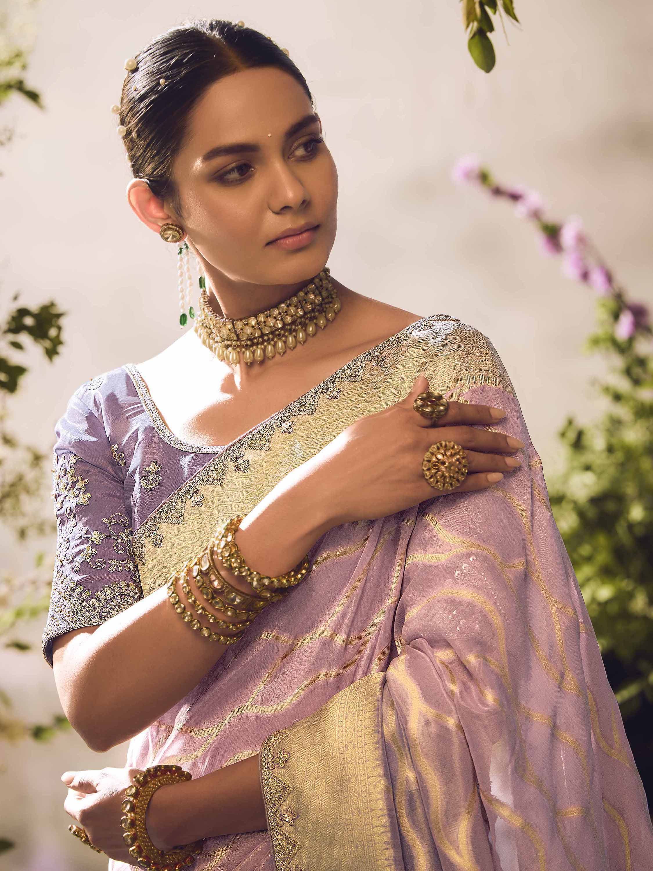 Woman in lavender and gold embroidered saree with traditional Indian jewelry, perfect for ethnic occasions