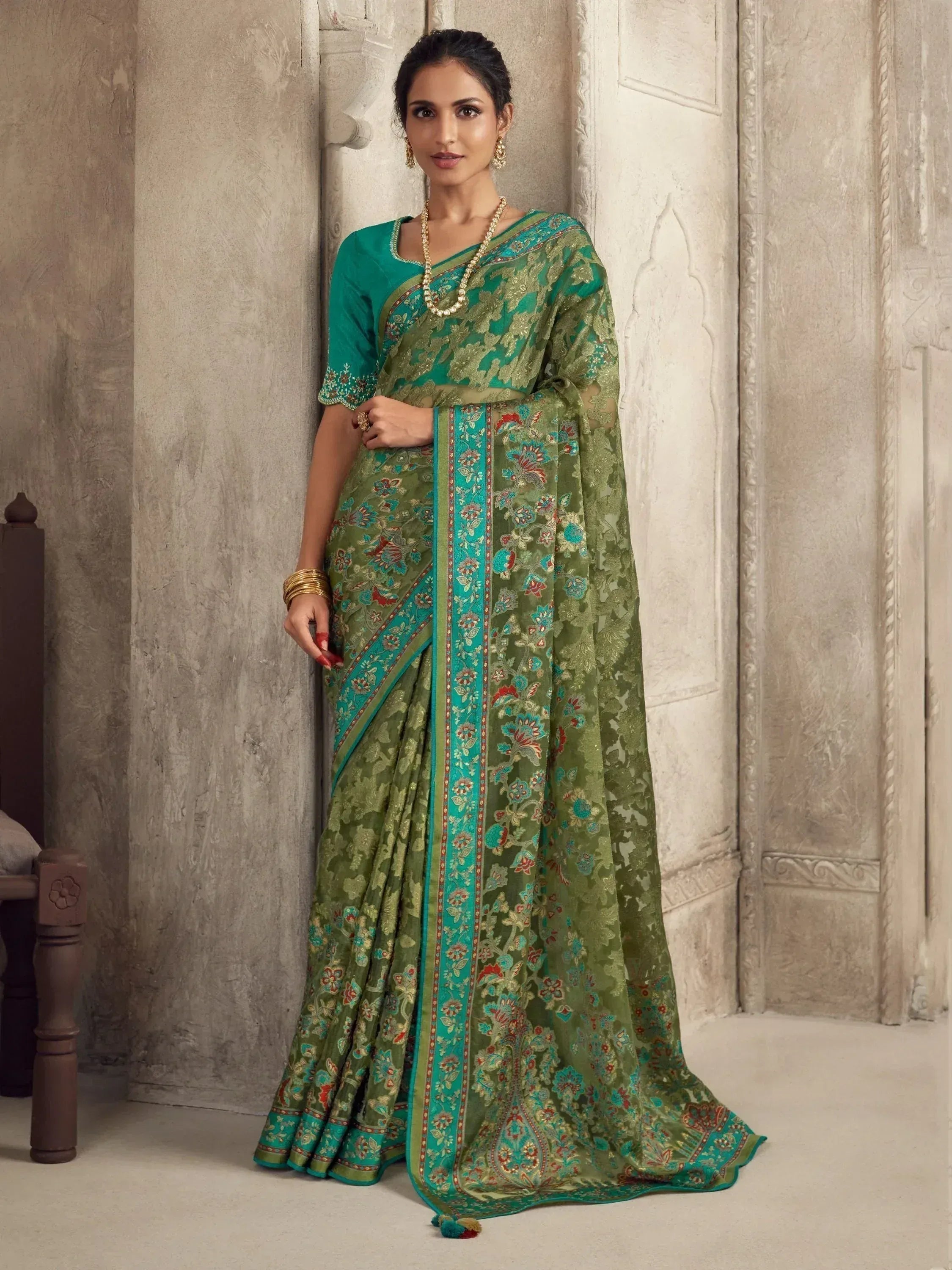 Elegant green floral saree with turquoise border, perfect for Indian ethnic wear occasions