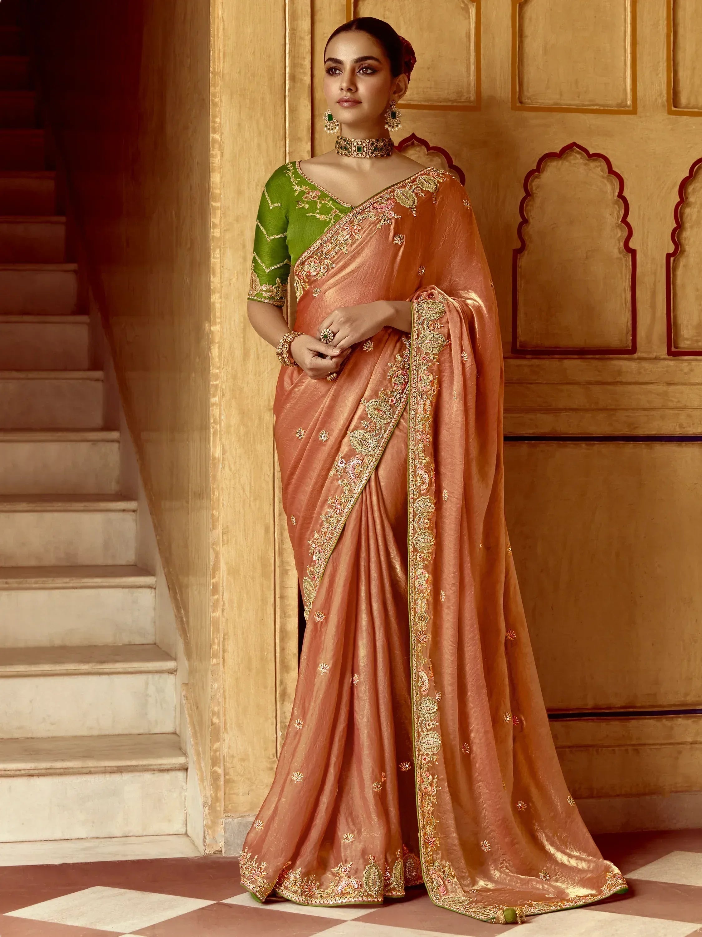Elegant peach saree with gold embroidery and green blouse, perfect for Indian ethnic wear occasions.
