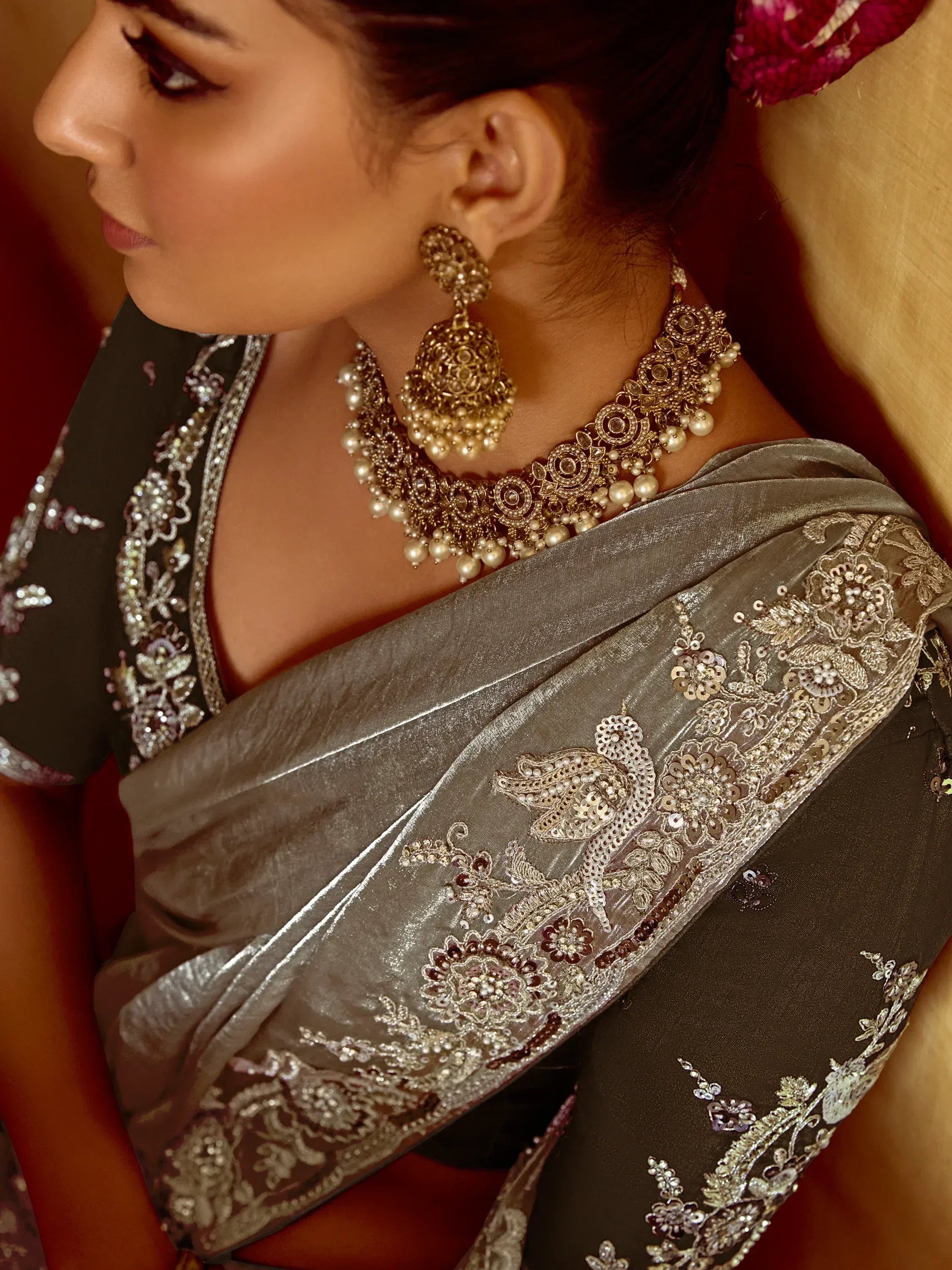Elegant Indian saree with intricate embroidery and gold jewelry for festive occasions