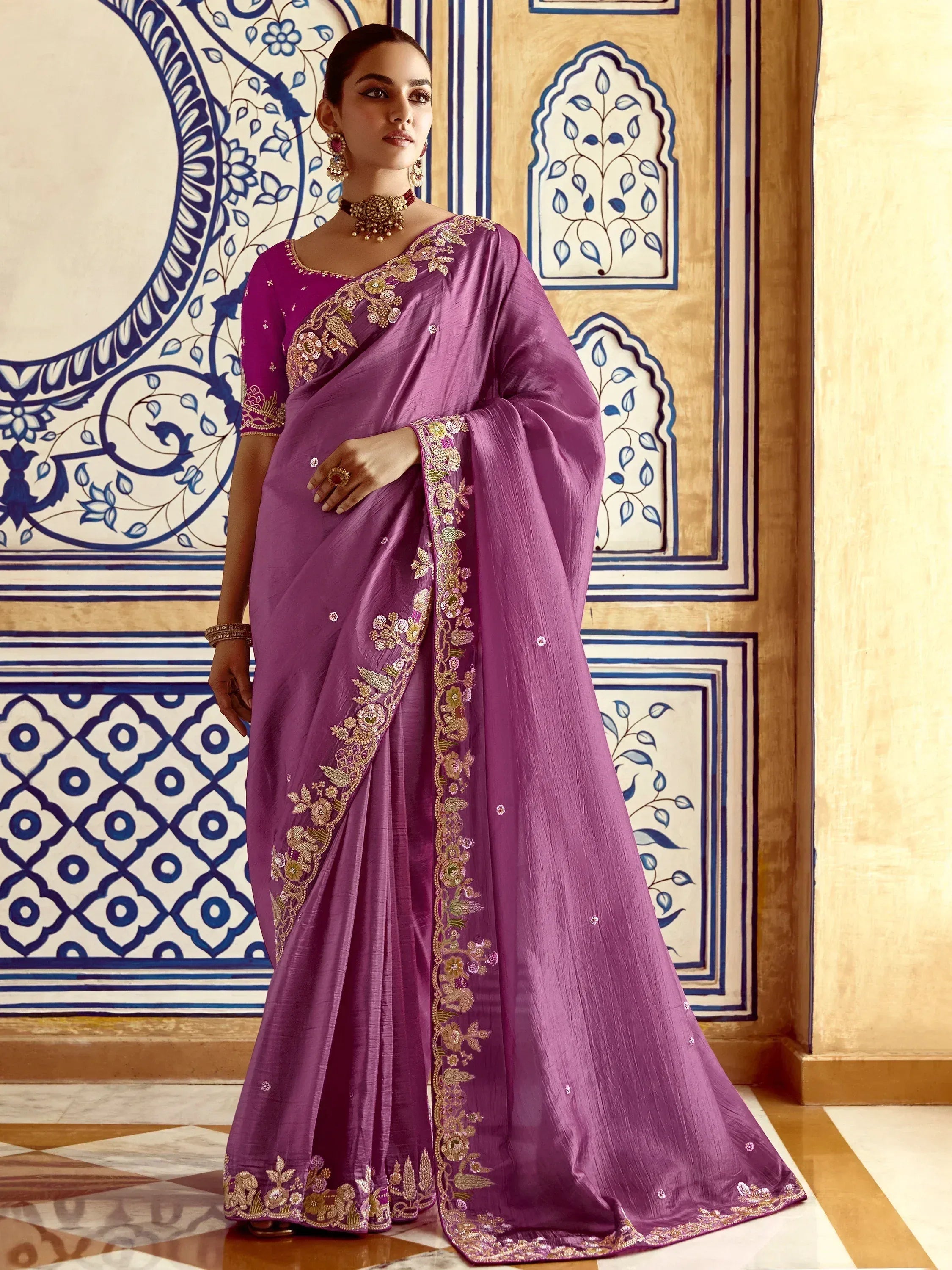 Purple embroidered saree with gold floral detailing, perfect for Indian ethnic wear occasions.