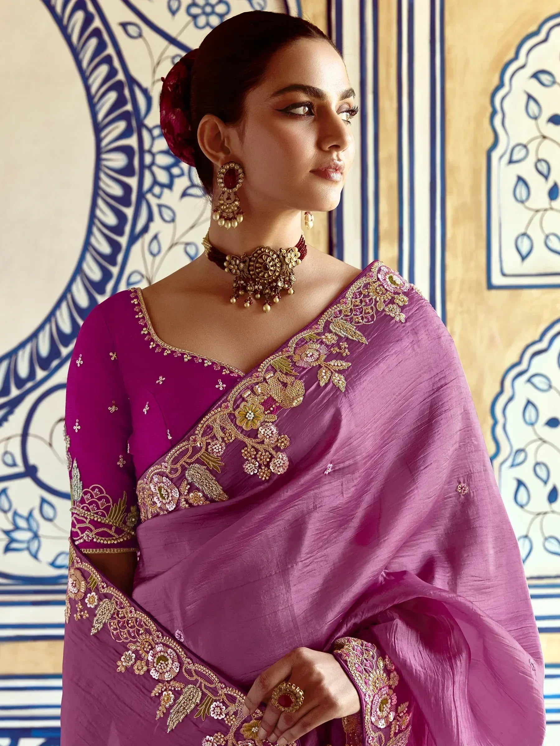 Elegant purple saree with gold floral embroidery and traditional jewelry
