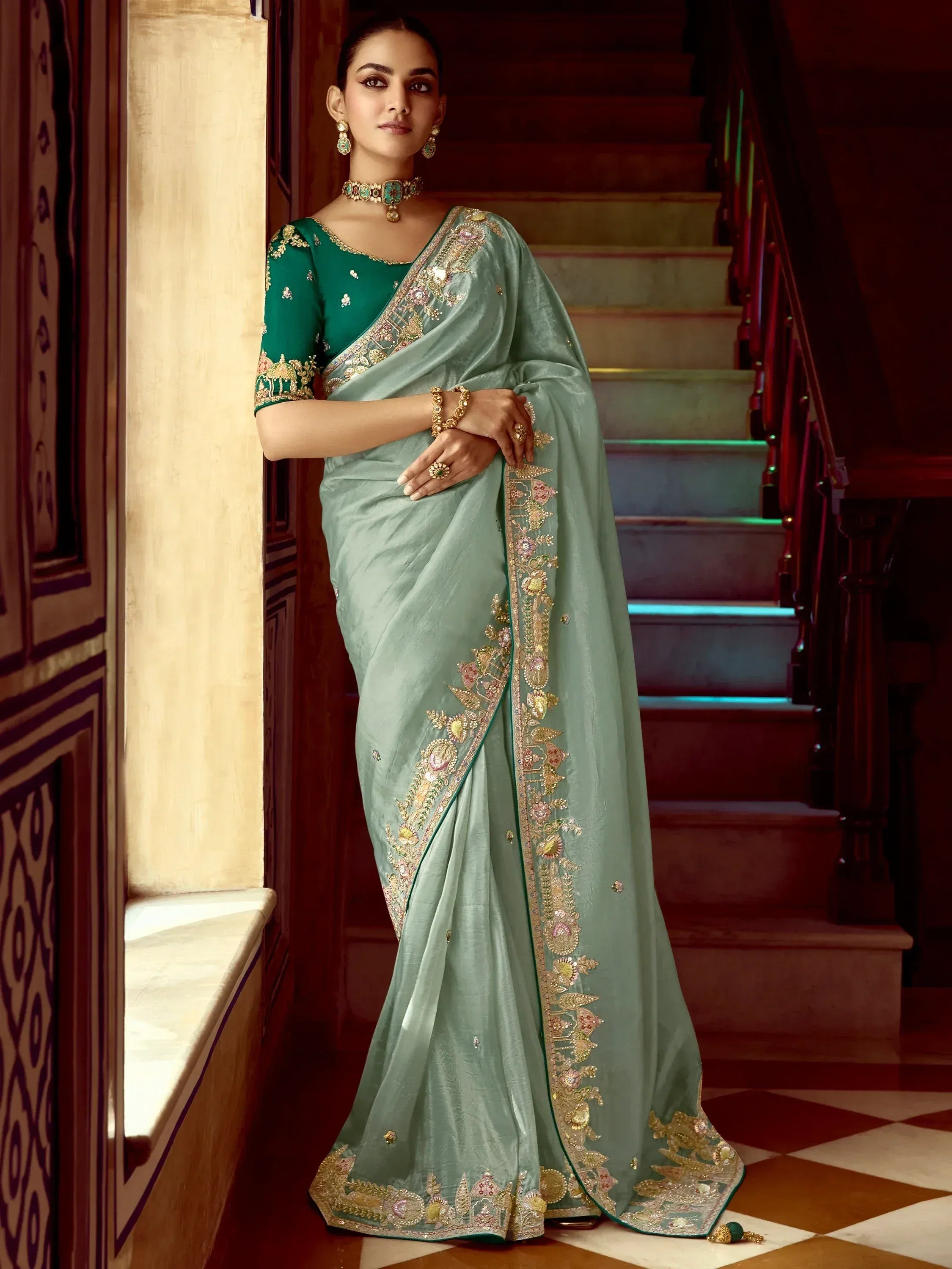 Elegant green saree with intricate gold embroidery, perfect for Indian ethnic wear occasions.