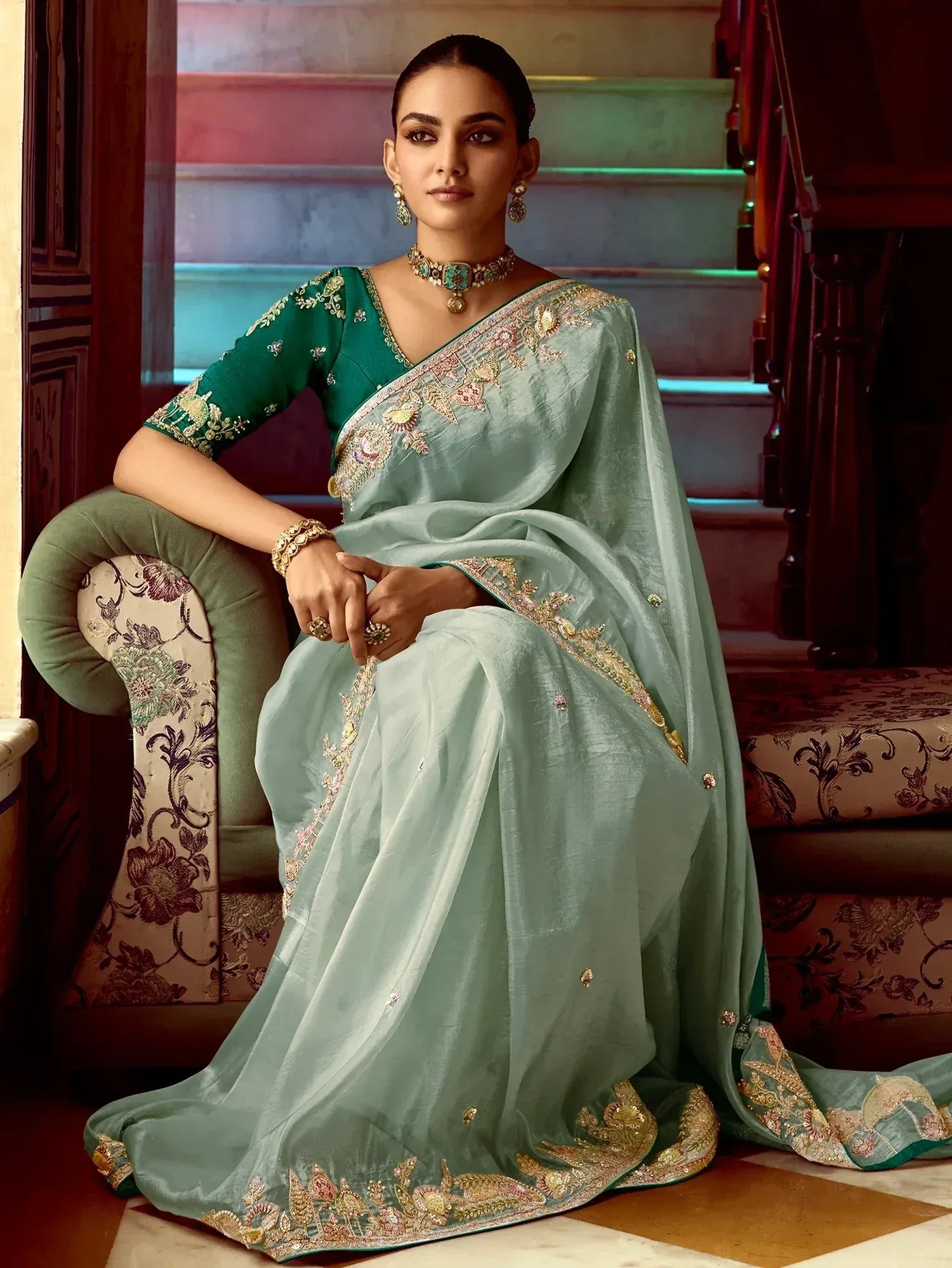 Elegant mint green saree with gold embroidery, paired with a green blouse and traditional jewelry.
