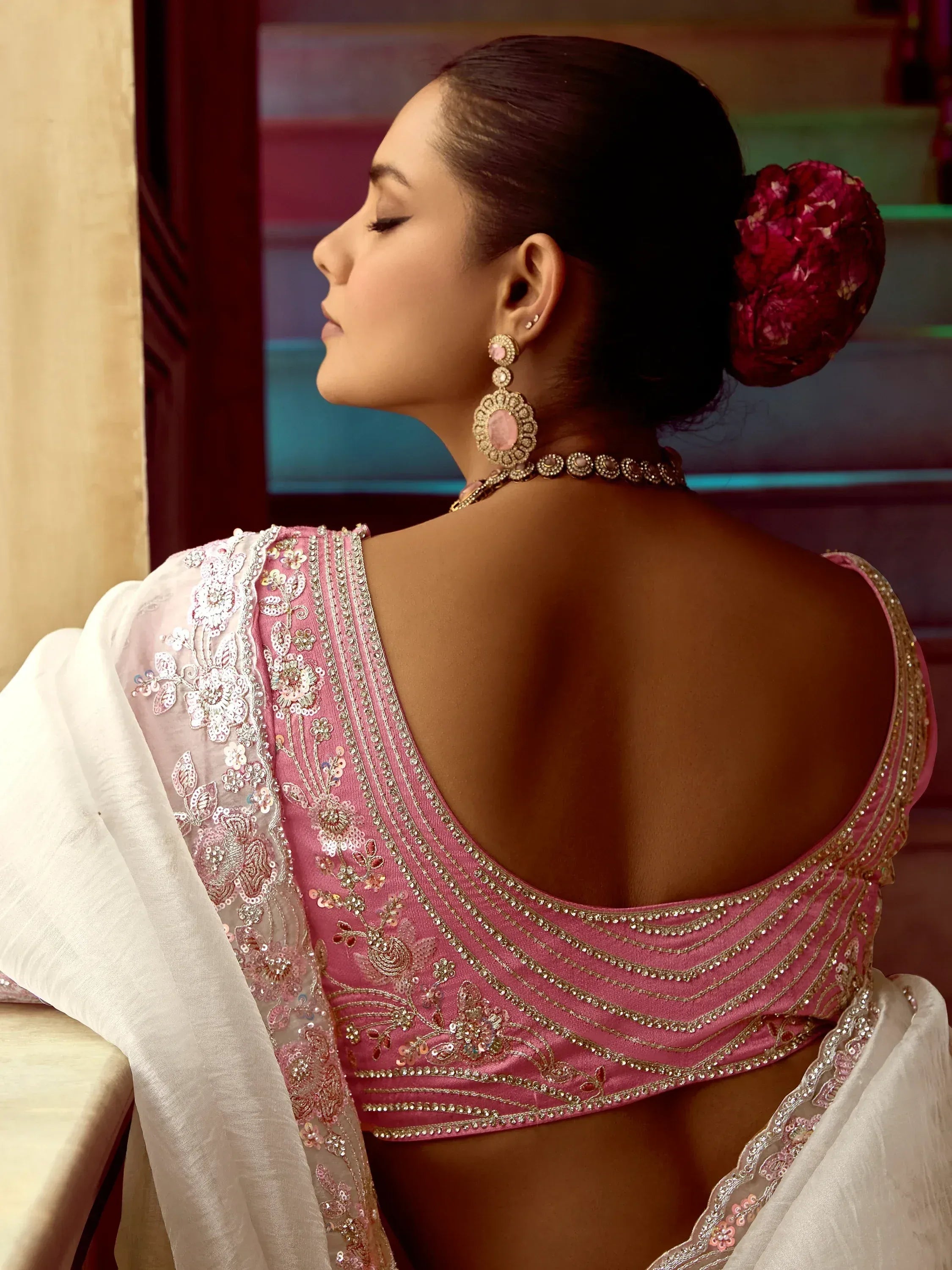 Elegant pink embroidered blouse with floral detailing and gold embellishments, paired with a white dupatta.