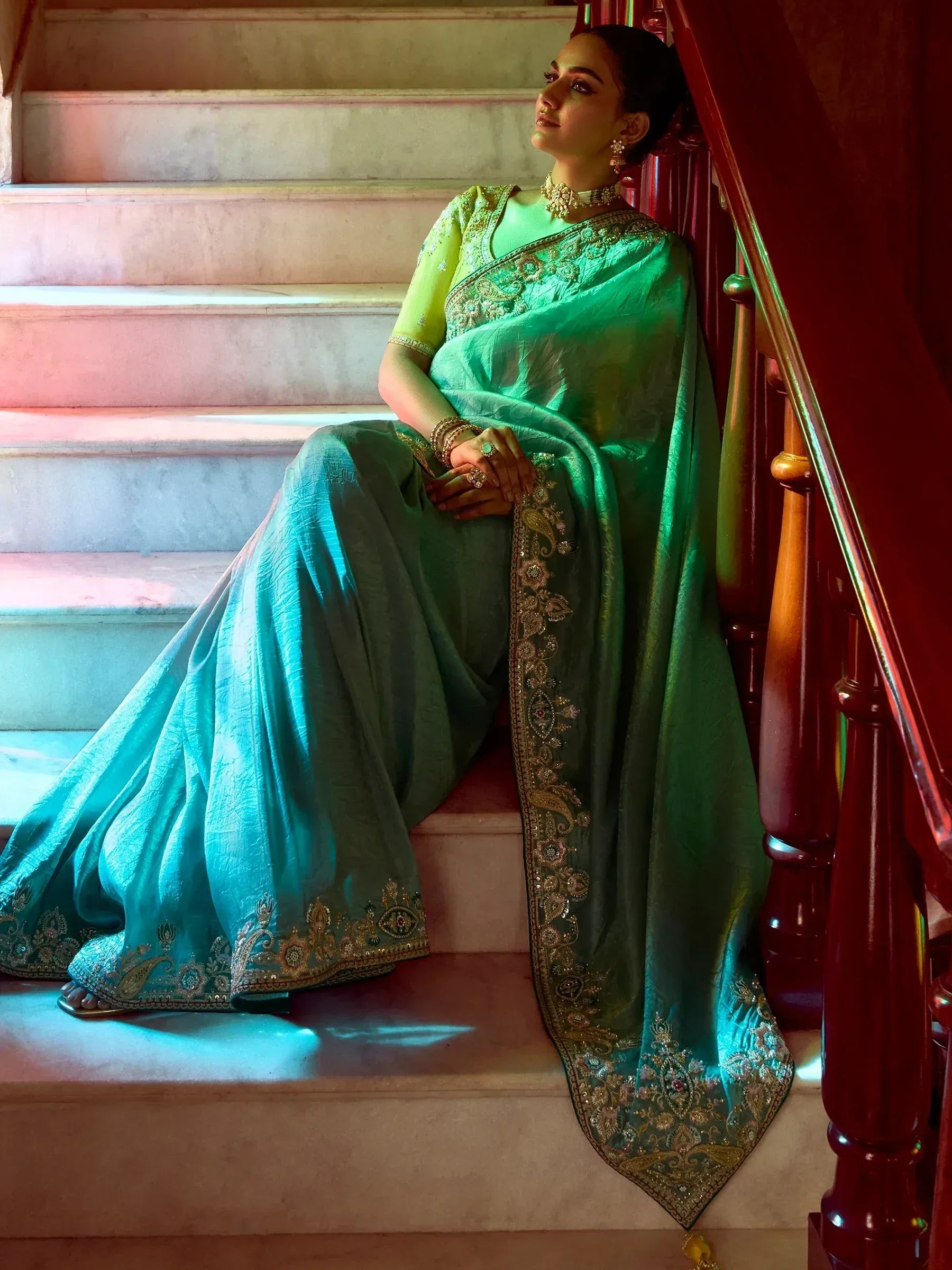 Elegant teal saree with gold embroidery, styled with matching blouse and jewelry, perfect for Indian ethnic wear.