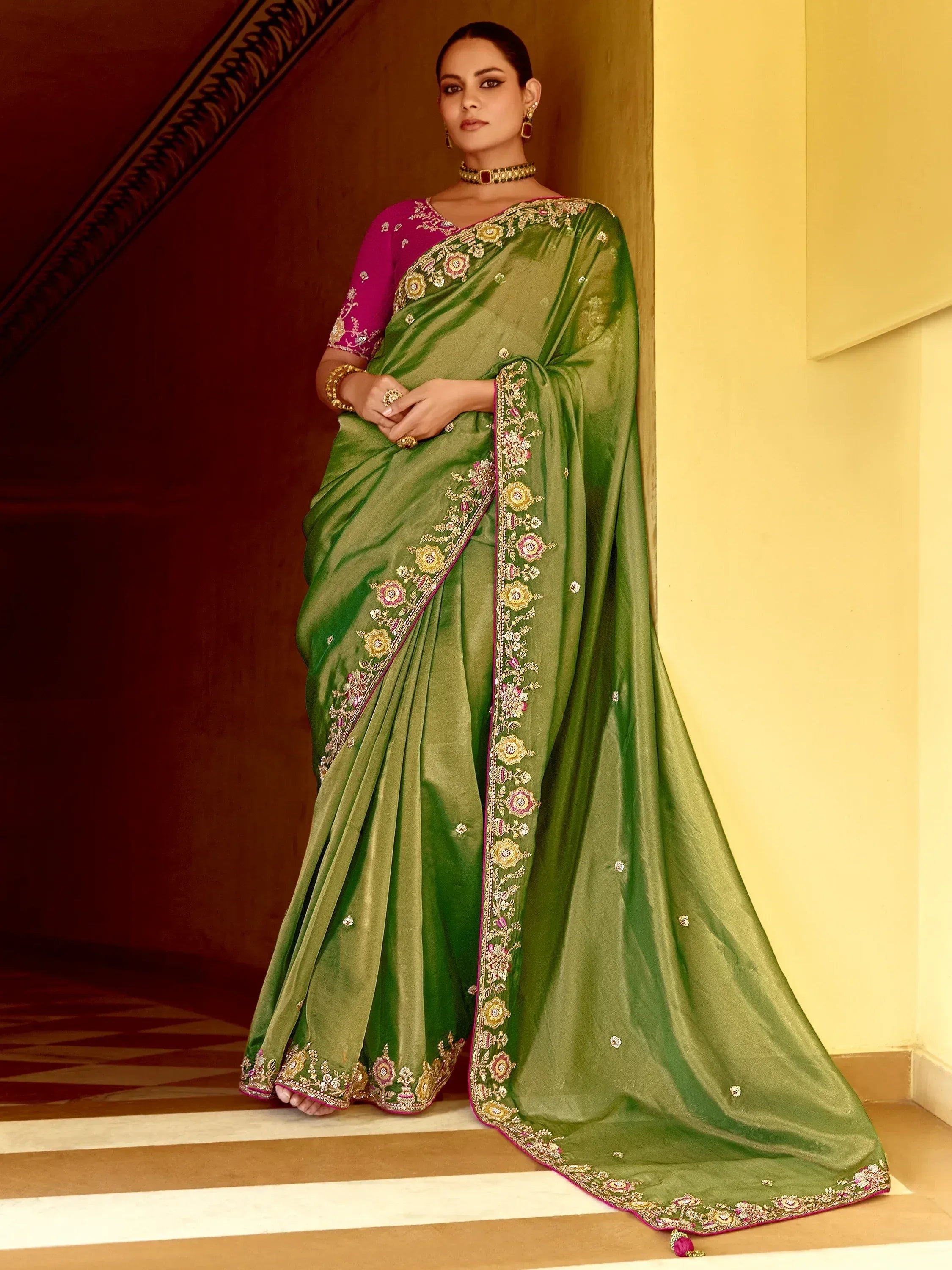 Green embroidered saree with pink blouse, floral detailing, and traditional Indian ethnic wear design