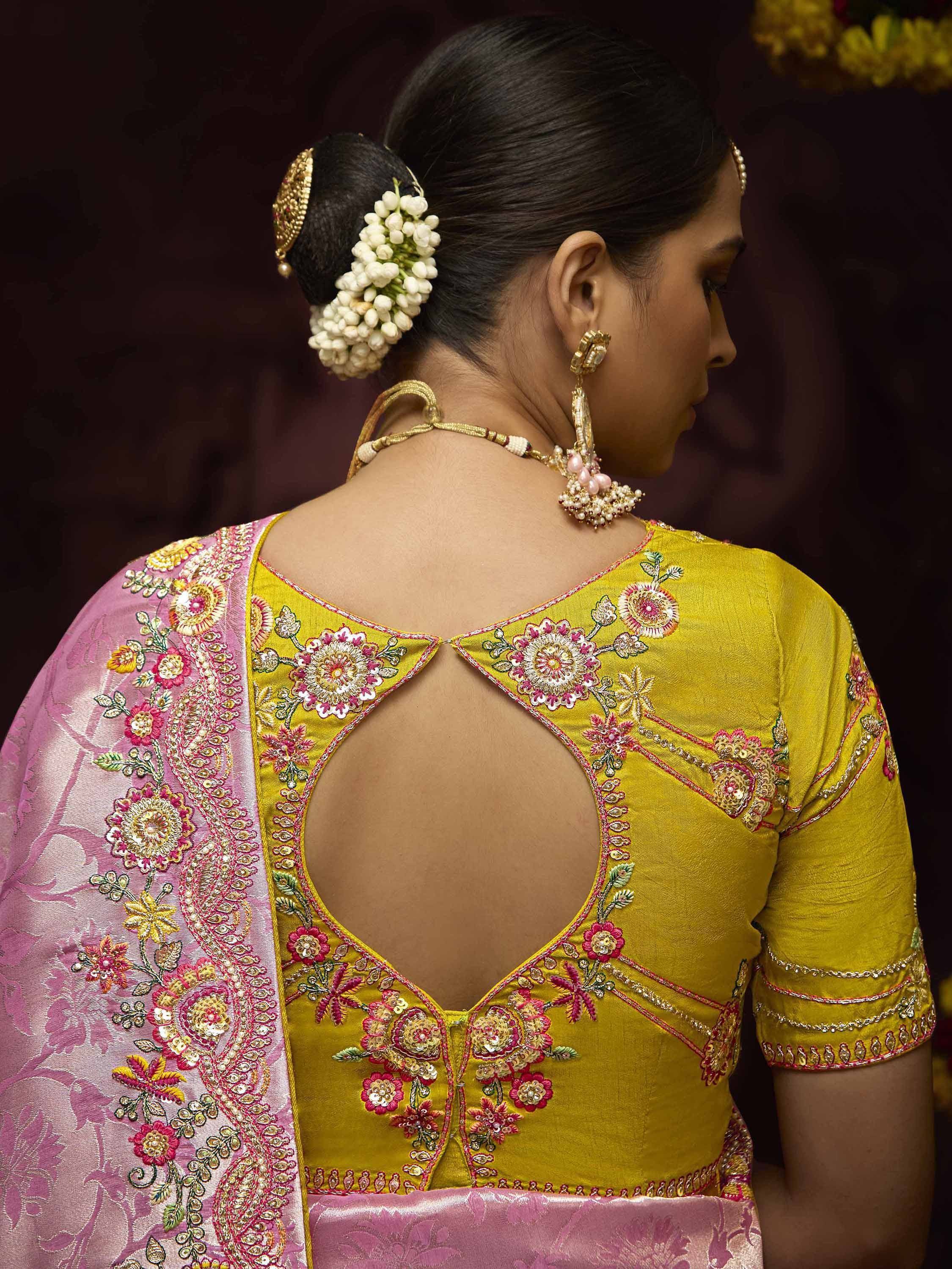 Yellow embroidered blouse with pink saree, floral back design, and traditional jewelry for Indian ethnic wear