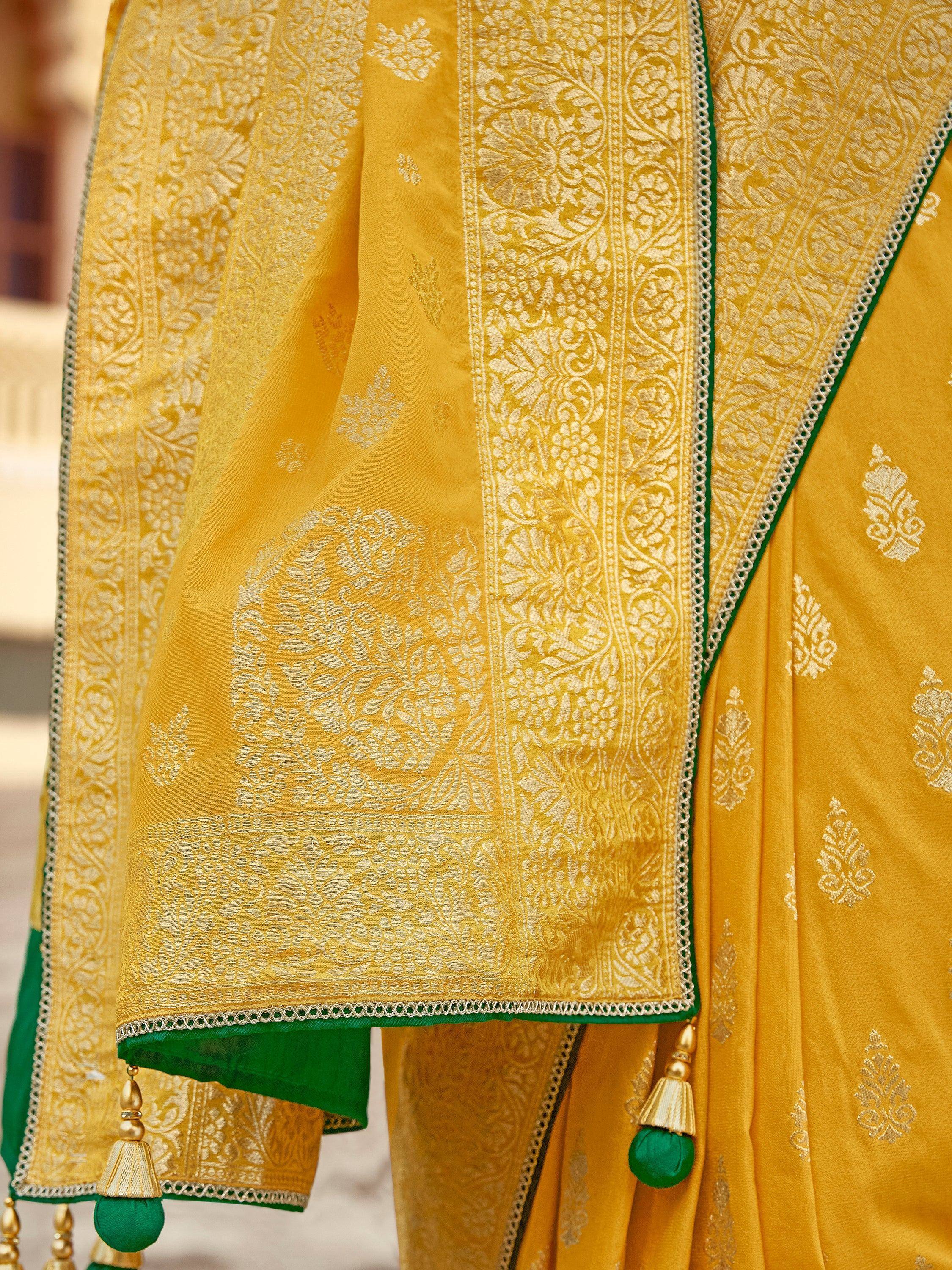 Yellow and green ethnic saree with intricate floral embroidery and tassels, perfect for Indian celebrations.