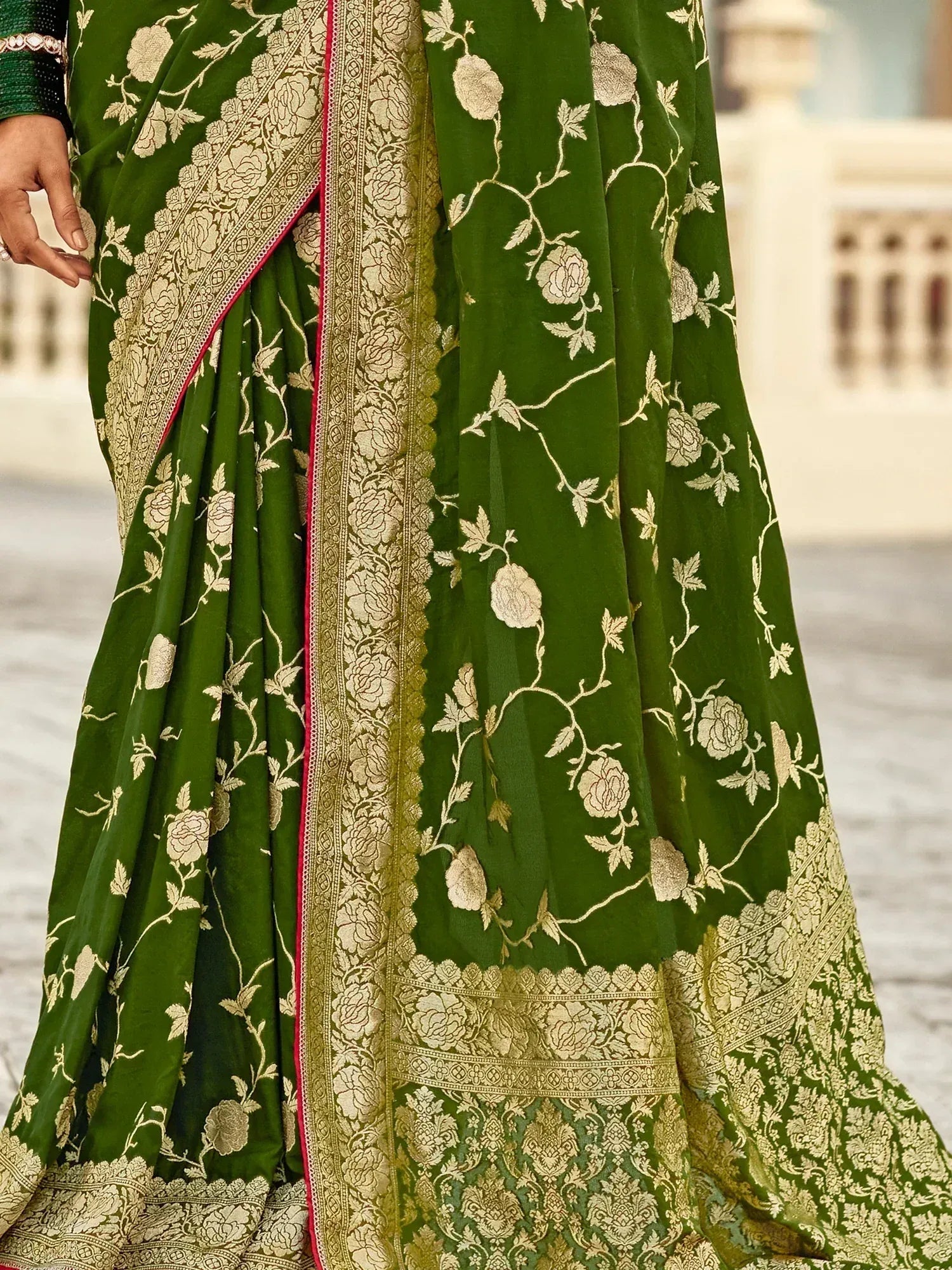 Green saree with gold floral embroidery and intricate border design