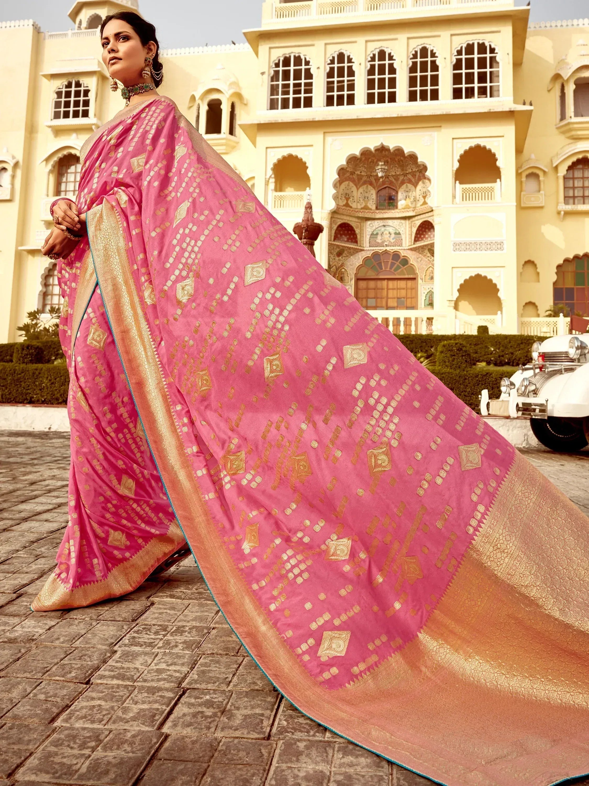 Pink designer saree with gold motifs, perfect for ethnic wear and festive occasions.