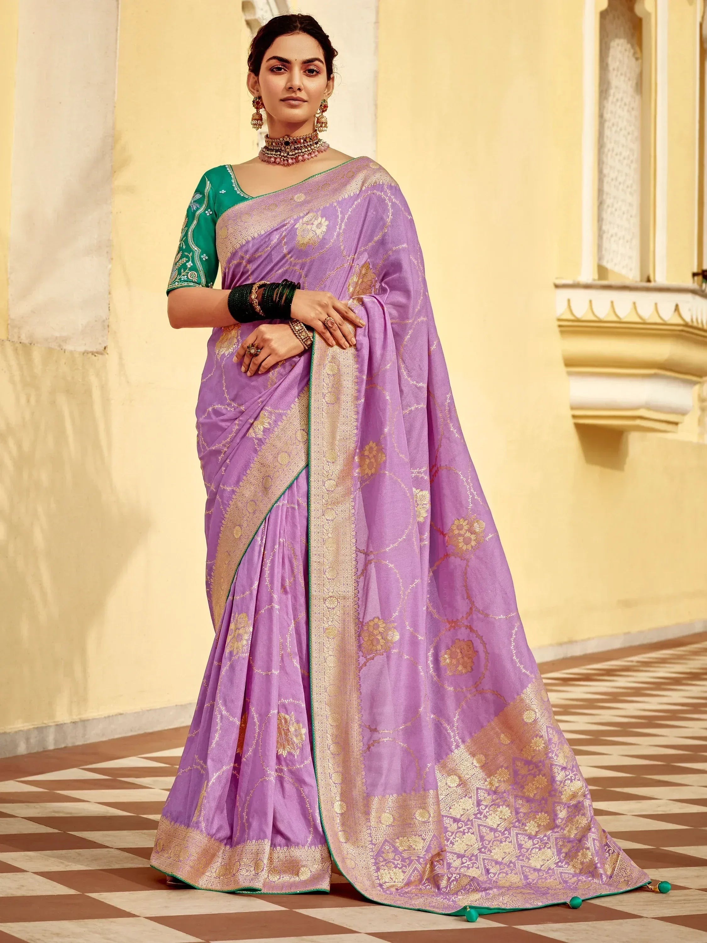 Purple designer saree with gold floral motifs and green blouse, perfect for Indian ethnic occasions.
