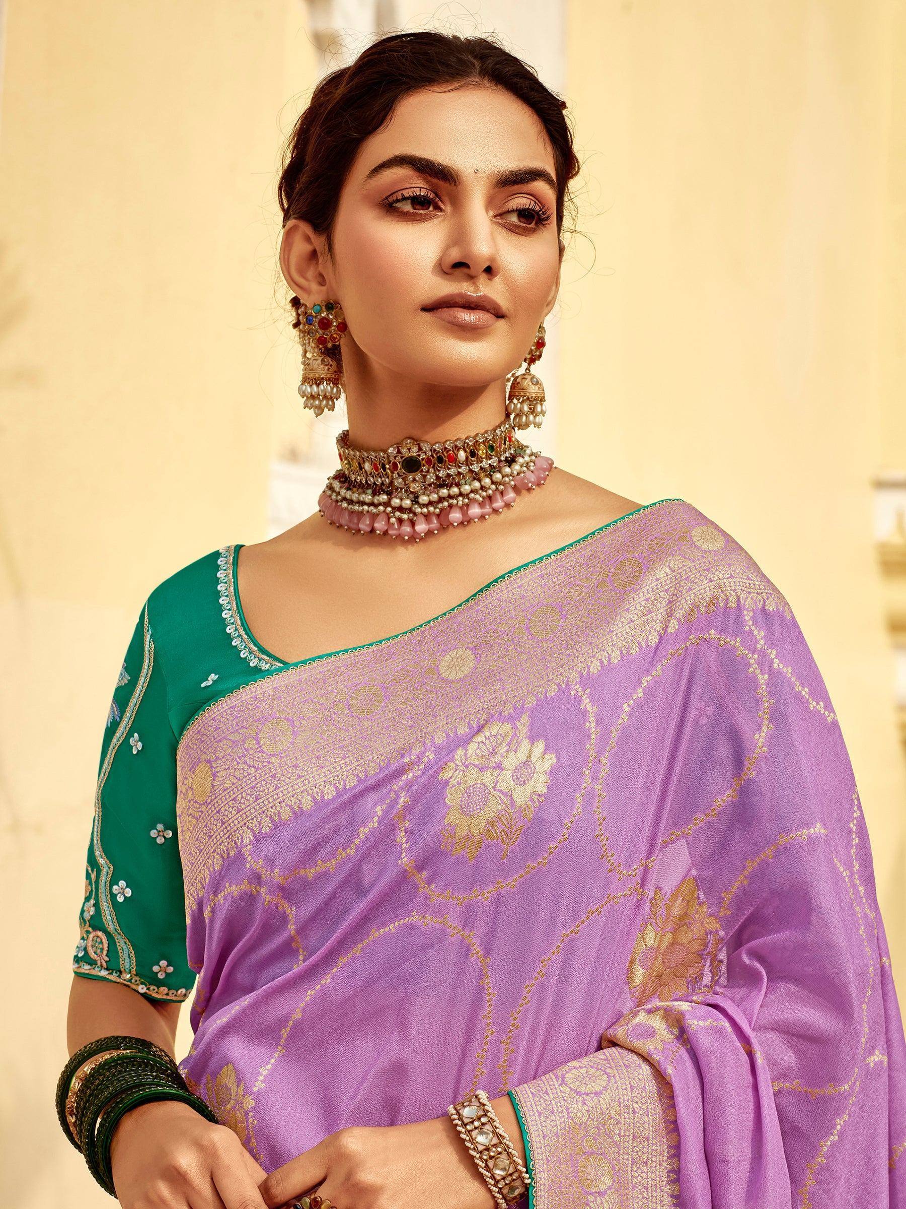 Purple saree with gold floral embroidery and green blouse, paired with traditional Indian jewelry