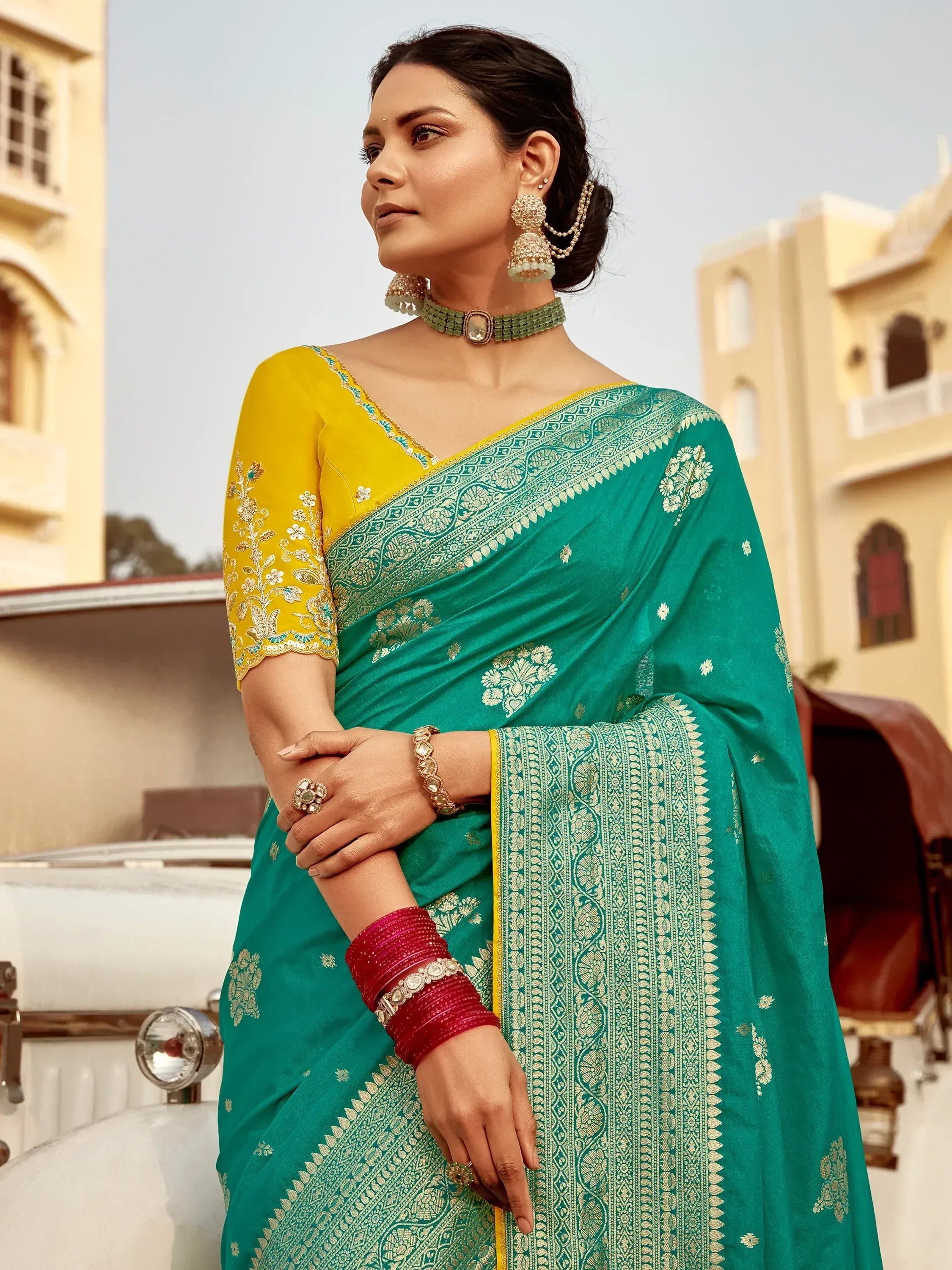 Elegant green saree with gold embroidery, paired with yellow blouse and traditional jewelry, perfect for Indian ethnic wear.