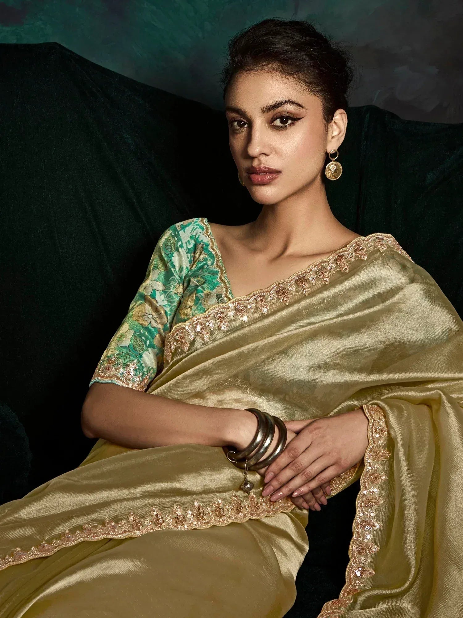 Elegant gold saree with floral green blouse, perfect for Indian ethnic wear and festive occasions.