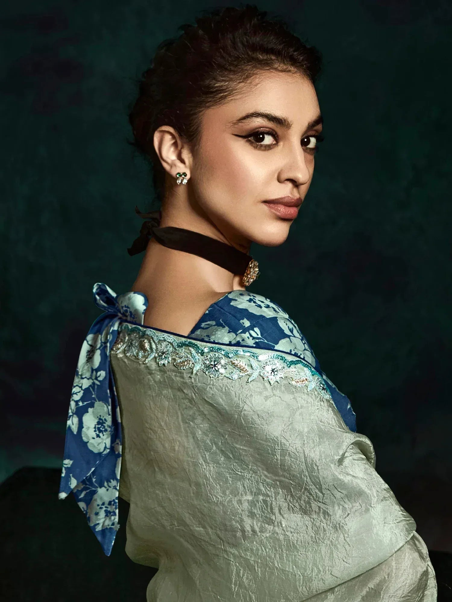 Woman in elegant ethnic gown with floral blue dupatta and embroidered neckline, styled for Indian occasions