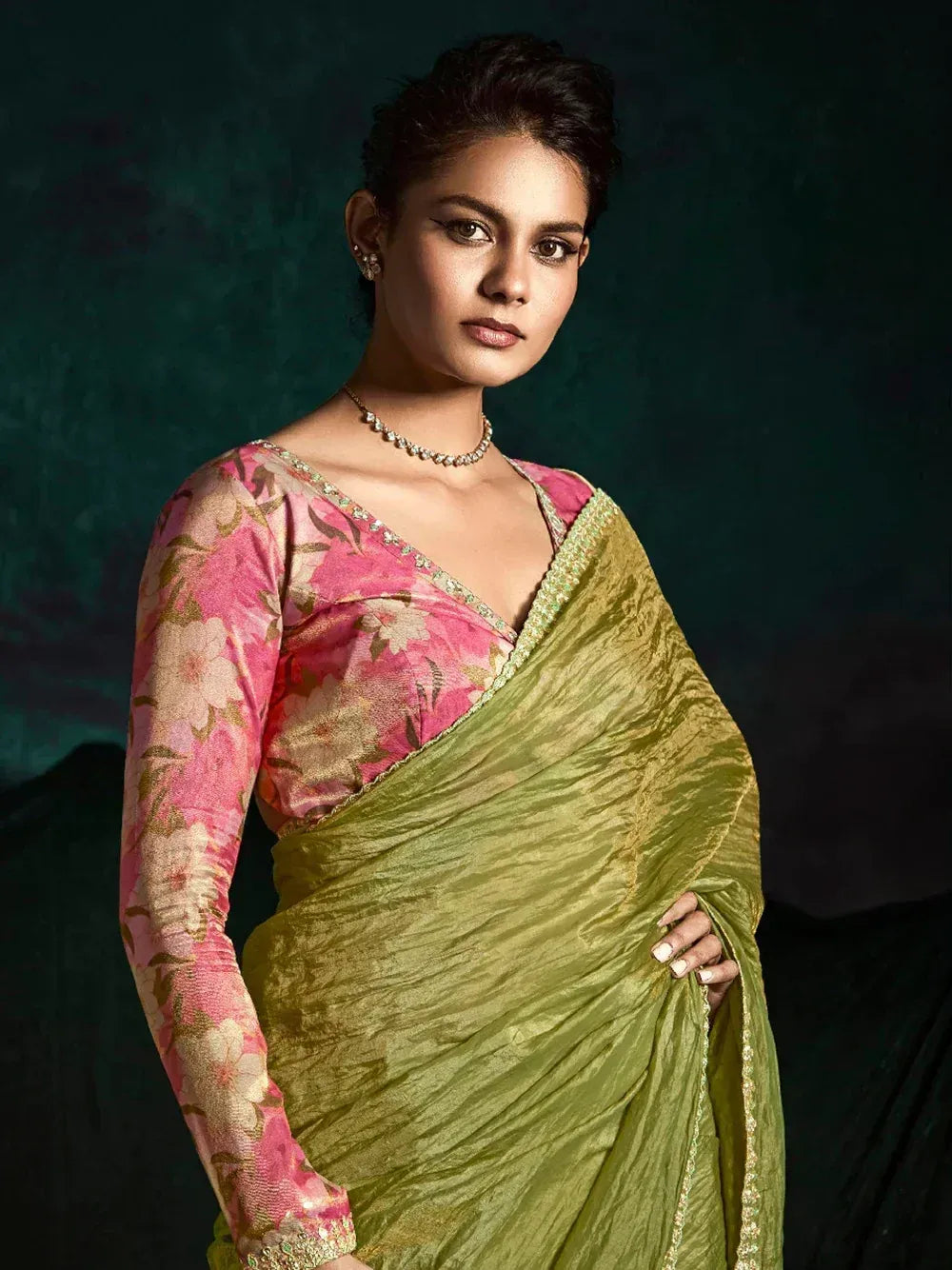 Woman in green saree with pink floral blouse, ethnic Indian wear for festive occasions