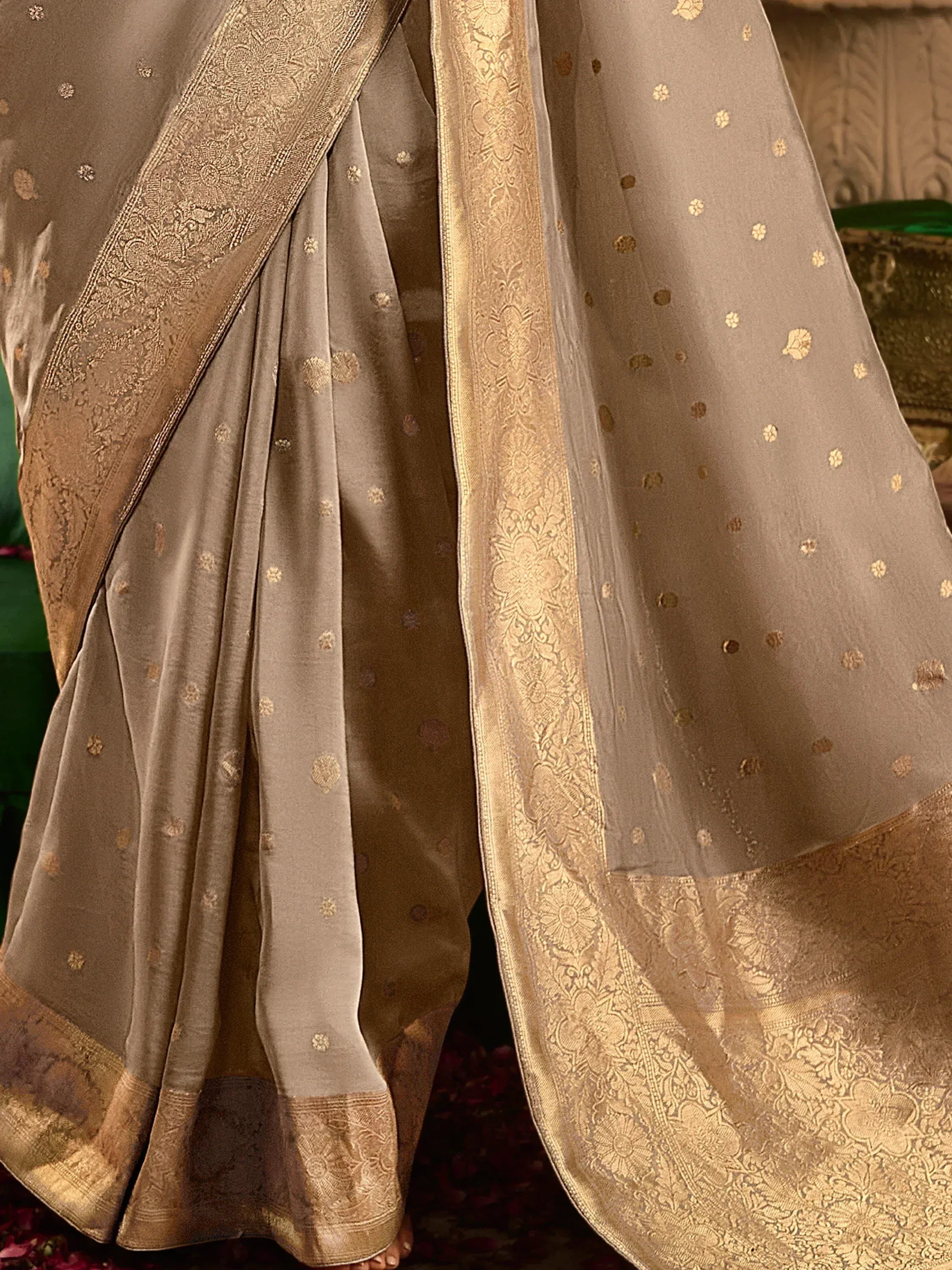 Elegant grey saree with gold floral motifs and intricate brocade border, perfect for ethnic occasions.