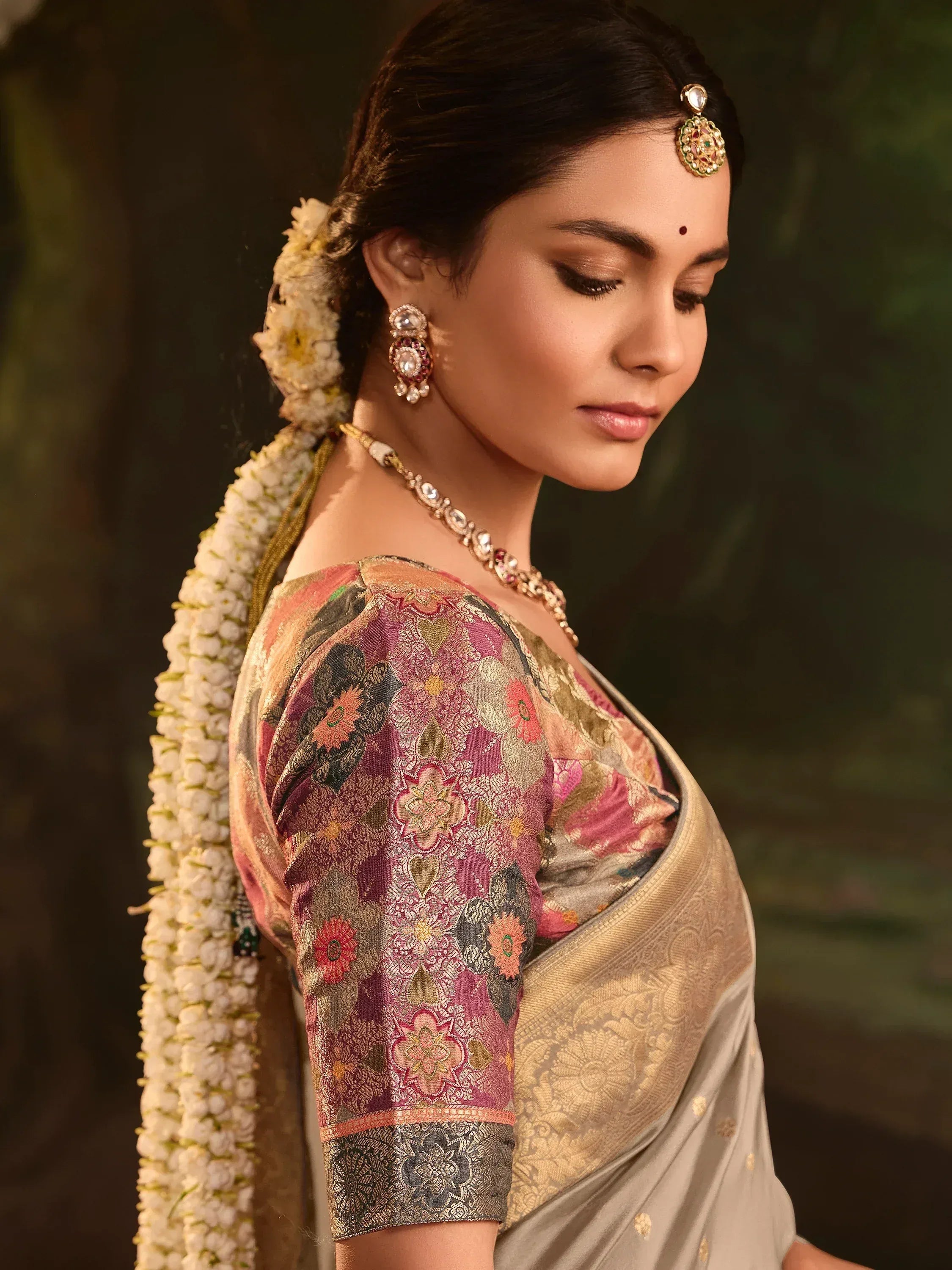 Elegant woman in floral blouse and saree with temple jewelry and jasmine gajra, traditional Indian ethnic wear