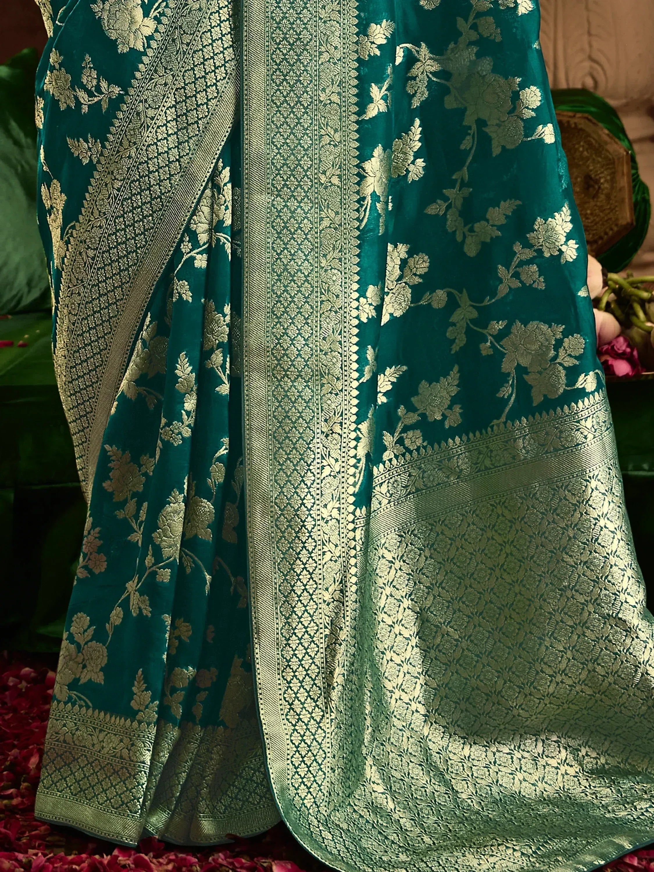 Teal saree with gold floral embroidery and intricate border design