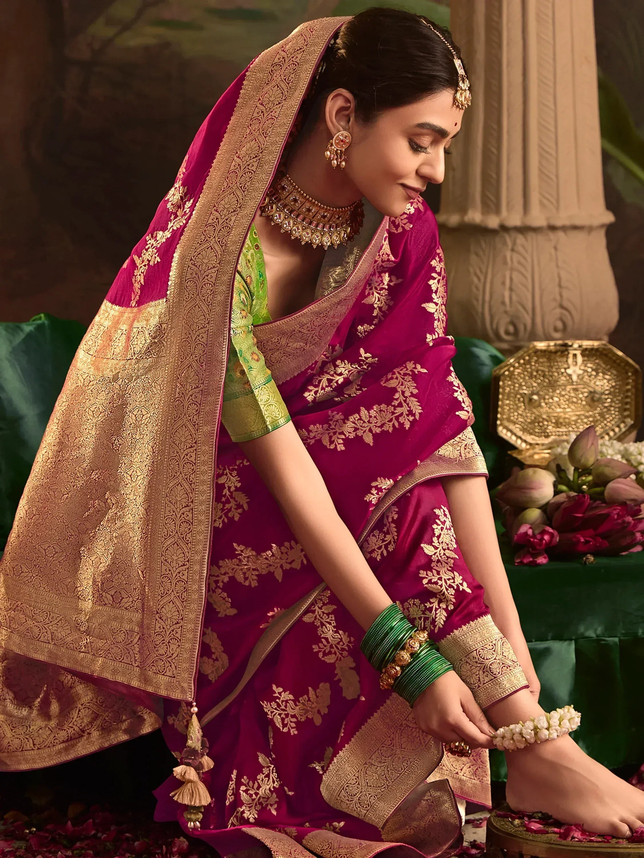 Elegant woman in maroon and gold embroidered saree with green blouse, traditional Indian ethnic wear