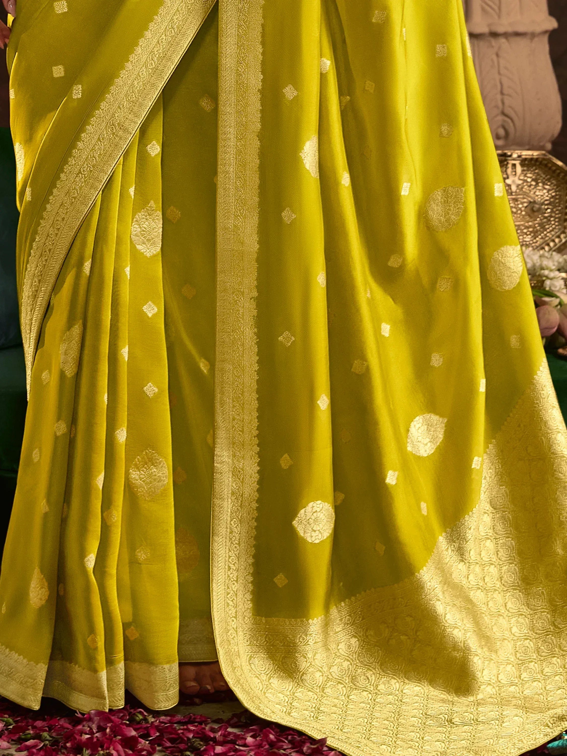 Vibrant yellow saree with golden floral motifs and intricate border, perfect for ethnic occasions.