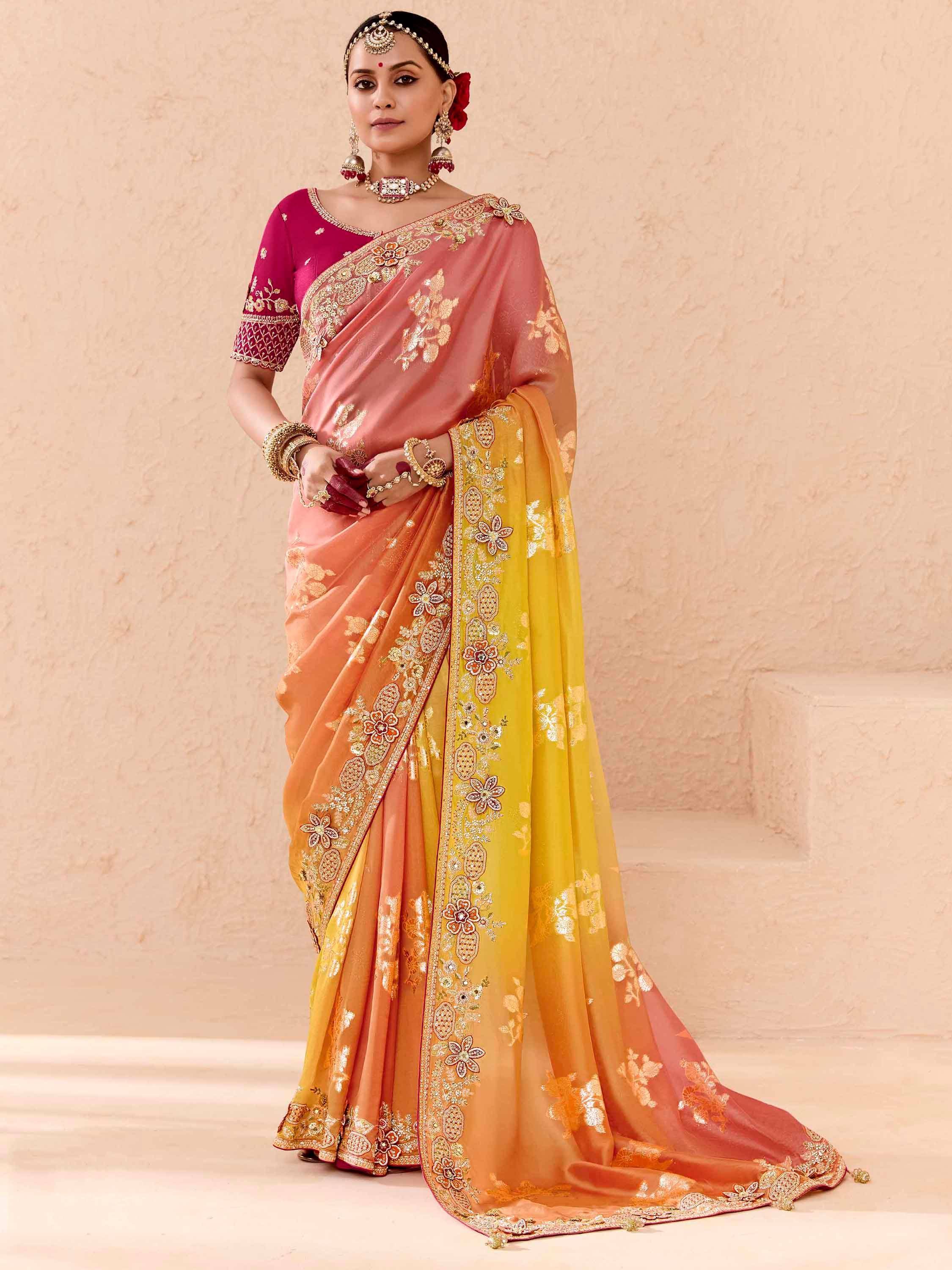 Woman in designer embroidered saree with pink, orange, yellow ombre and gold floral work, perfect for Indian ethnic occasions
