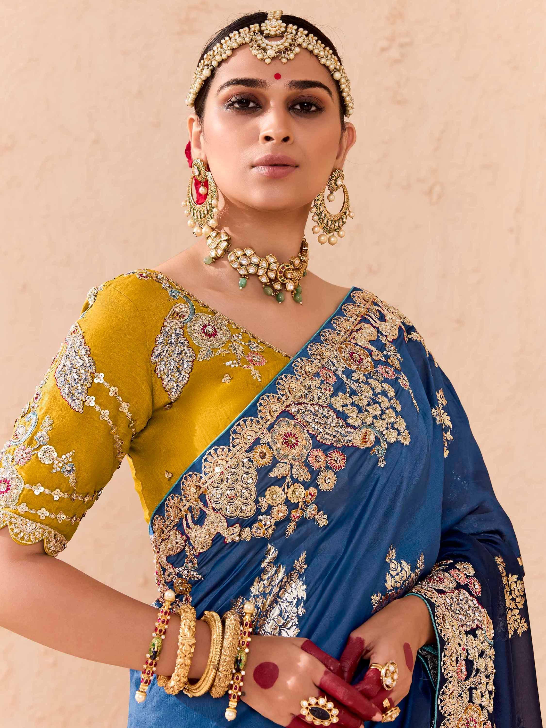Elegant blue and mustard embroidered saree with traditional Indian jewelry for festive occasions