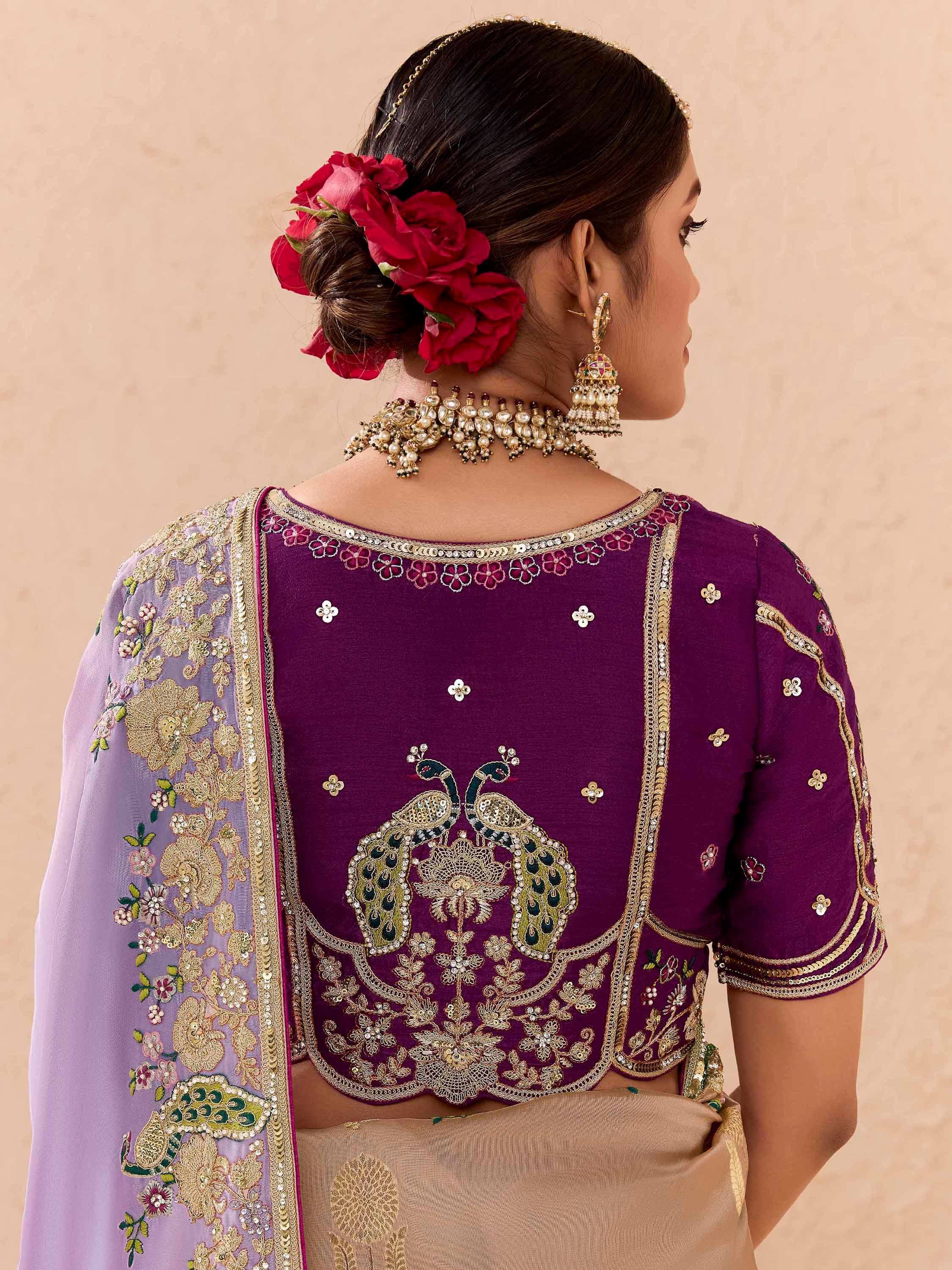 Purple embroidered blouse with peacock design, floral dupatta, and traditional Indian jewelry
