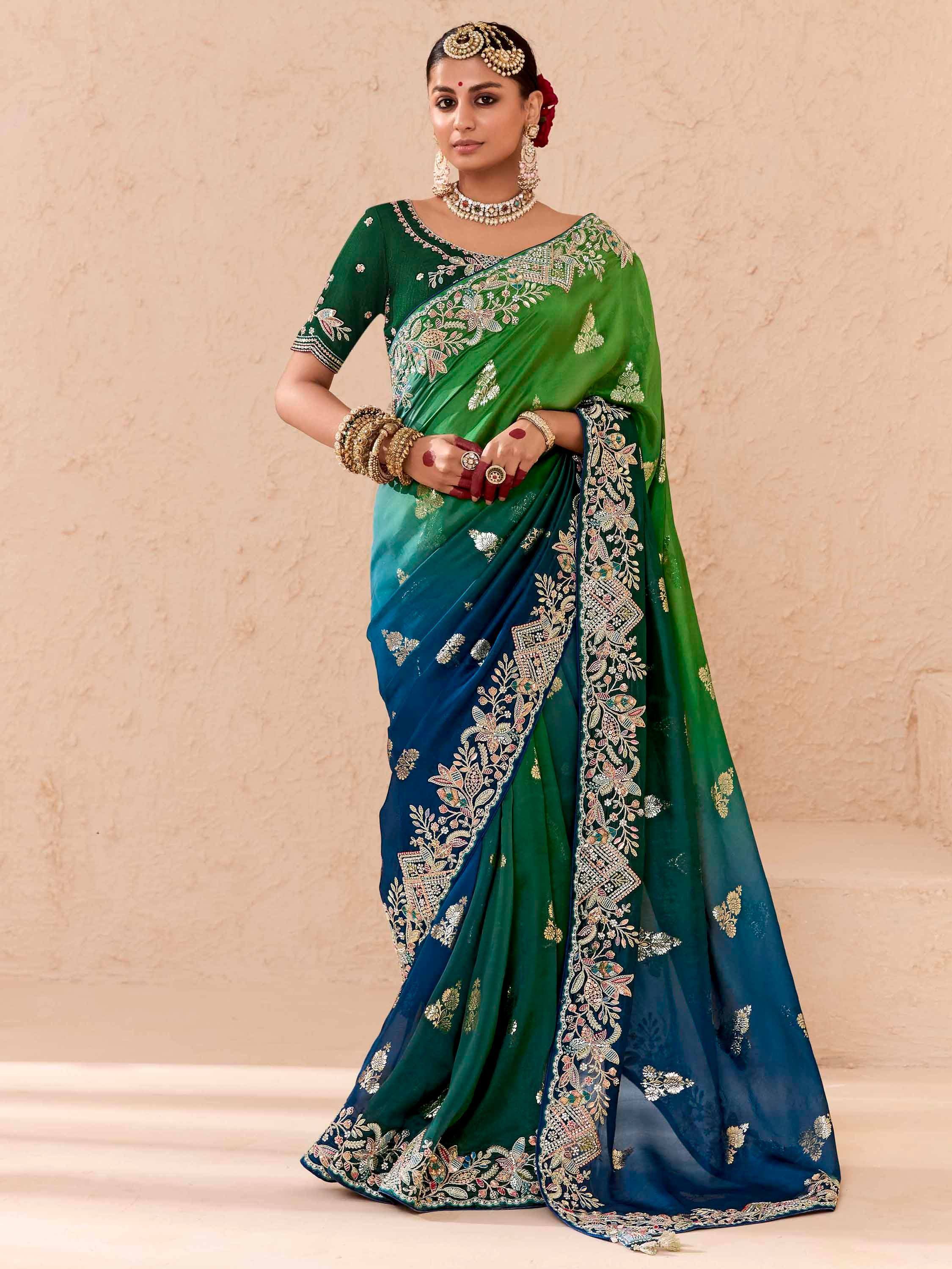 Emerald green and blue embroidered saree with floral zari work, perfect for Indian ethnic occasions.