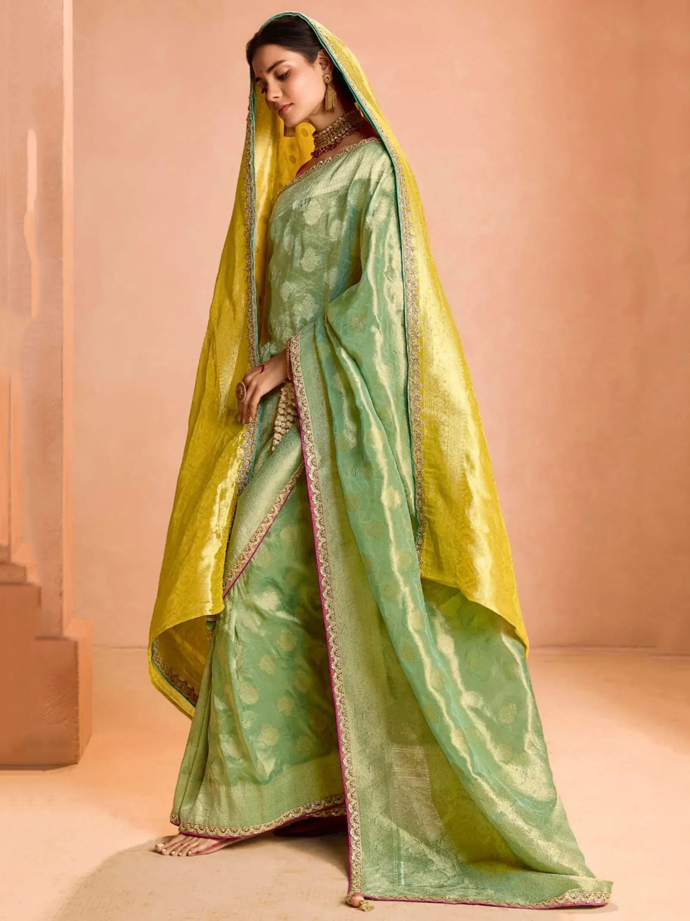 Mint green and yellow designer saree with gold embroidery, perfect for Indian ethnic occasions