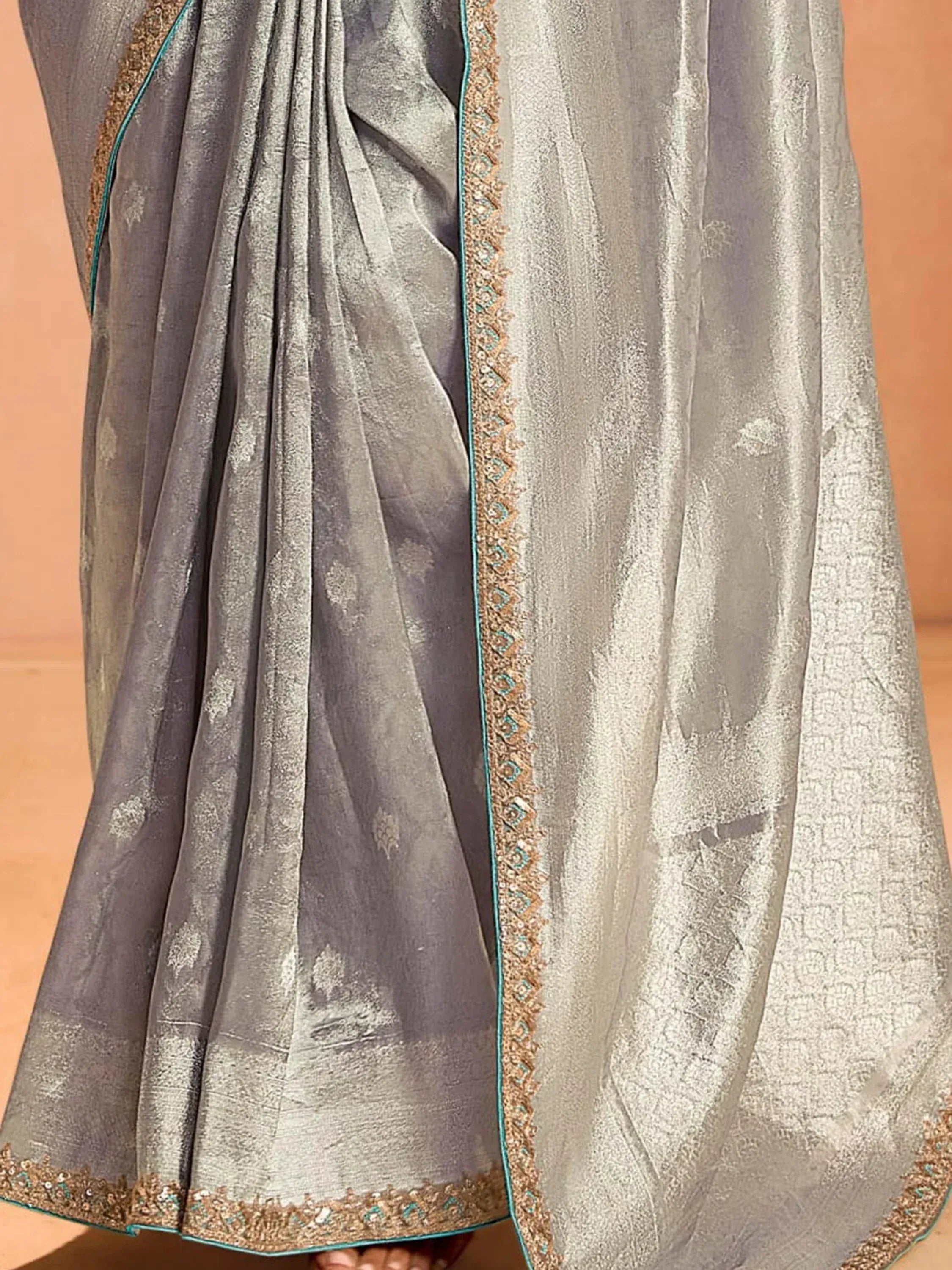 Grey designer saree with gold and teal embroidery, perfect for ethnic wear occasions