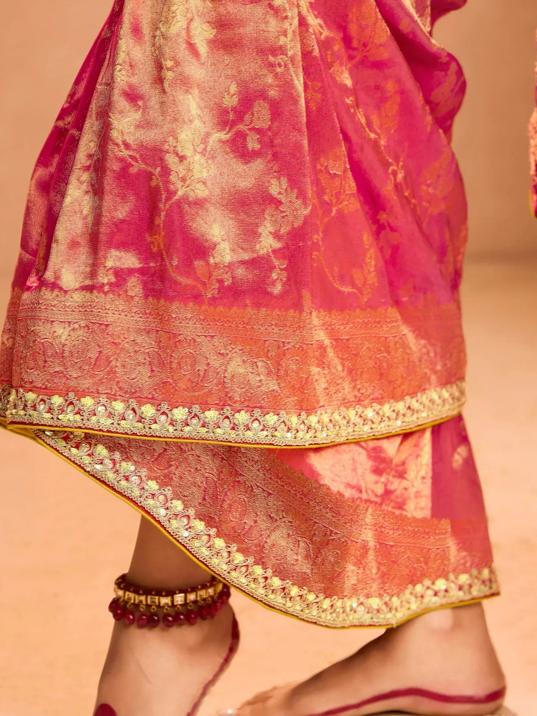 Pink and gold embroidered lehenga with detailed border and anklet, Indian ethnic wear